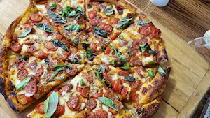 A homemade pizza on a wooden serving board. (Photo from Wikimedia Commons)