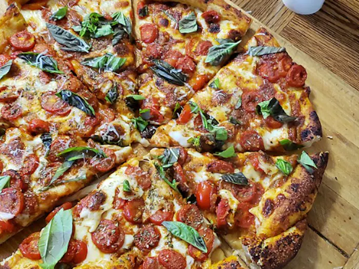 A homemade pizza on a wooden serving board. (Photo from Wikimedia Commons)