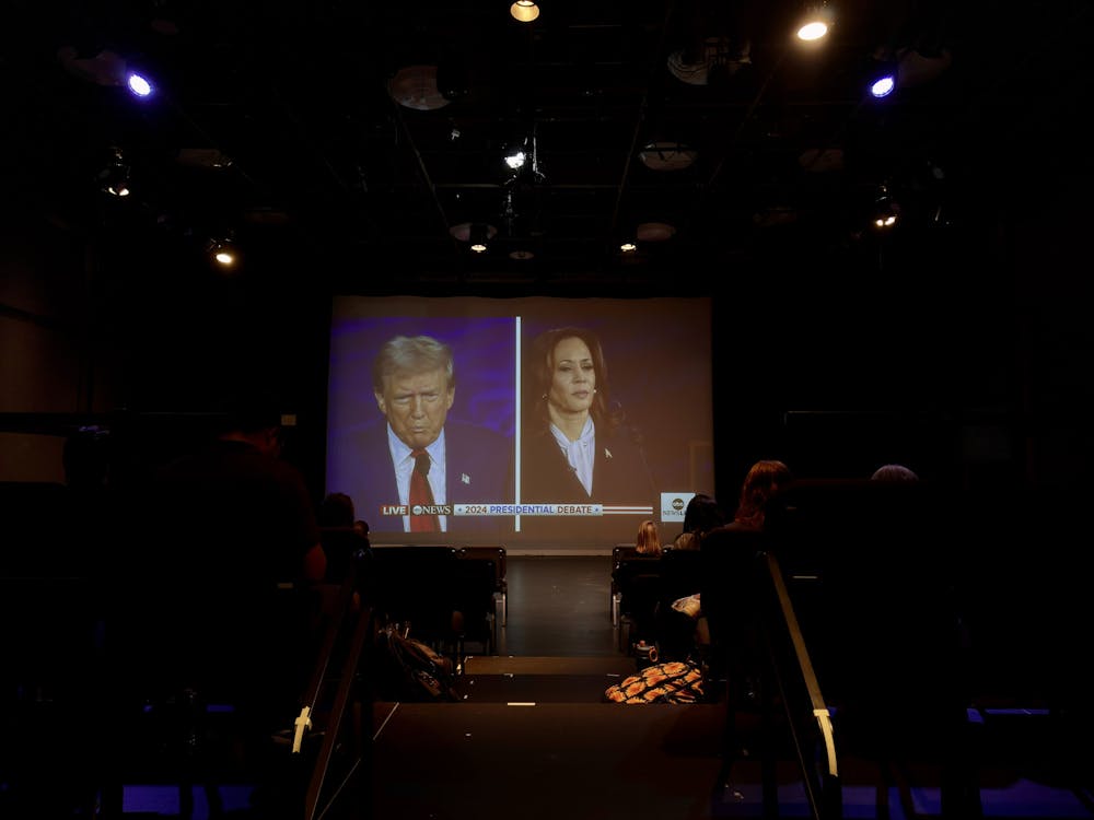 <p><em>Attendees of the watch party got to experience the presidential debate on the big screen in Kendall Hall’s black box theater (Photo by Matthew Kaufman).</em></p>