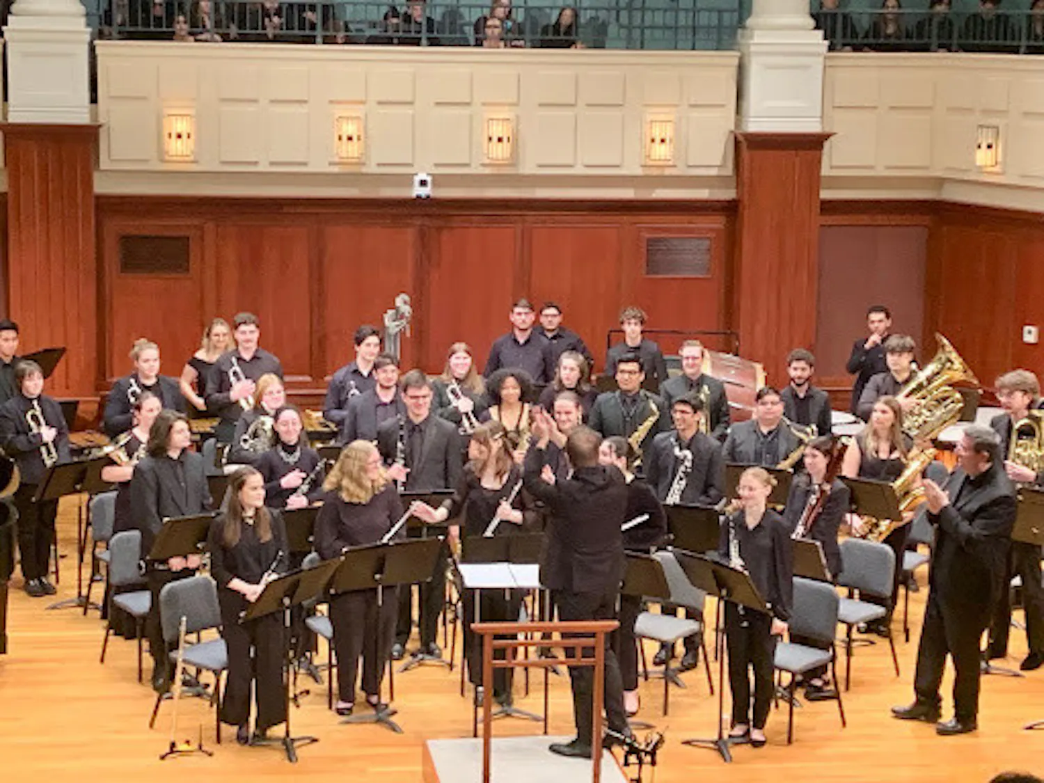 The College’s wind ensemble applauds Director Eric Laprade. (Photo by Grace Gorsline)