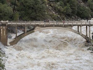 Just one month into the new year, people are already experiencing intense flooding and destruction across California as homes and schools are left as debris (Photo courtesy of Wikimedia Commons / “Flood under the Old Route 49 bridge crossing over the South Yuba River in Nevada City, California” by Kelly M. Grow/ California Department of Water Resources. PD California. January 9, 2017). 