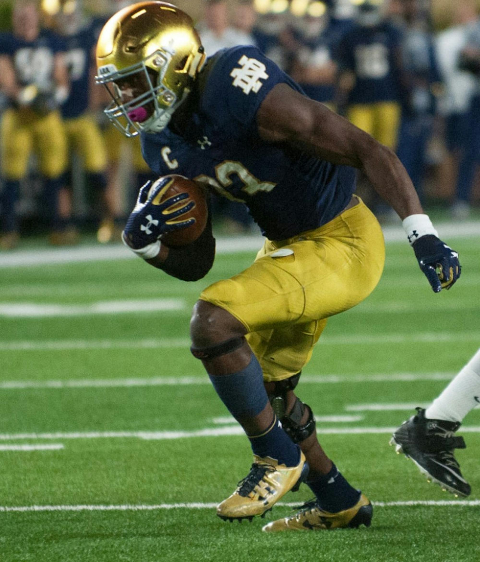 Irish junior running back Josh Adams looks downfield as he passes a defender during Notre Dame's 49-14 win over USC on Saturday at Notre Dame Stadium.