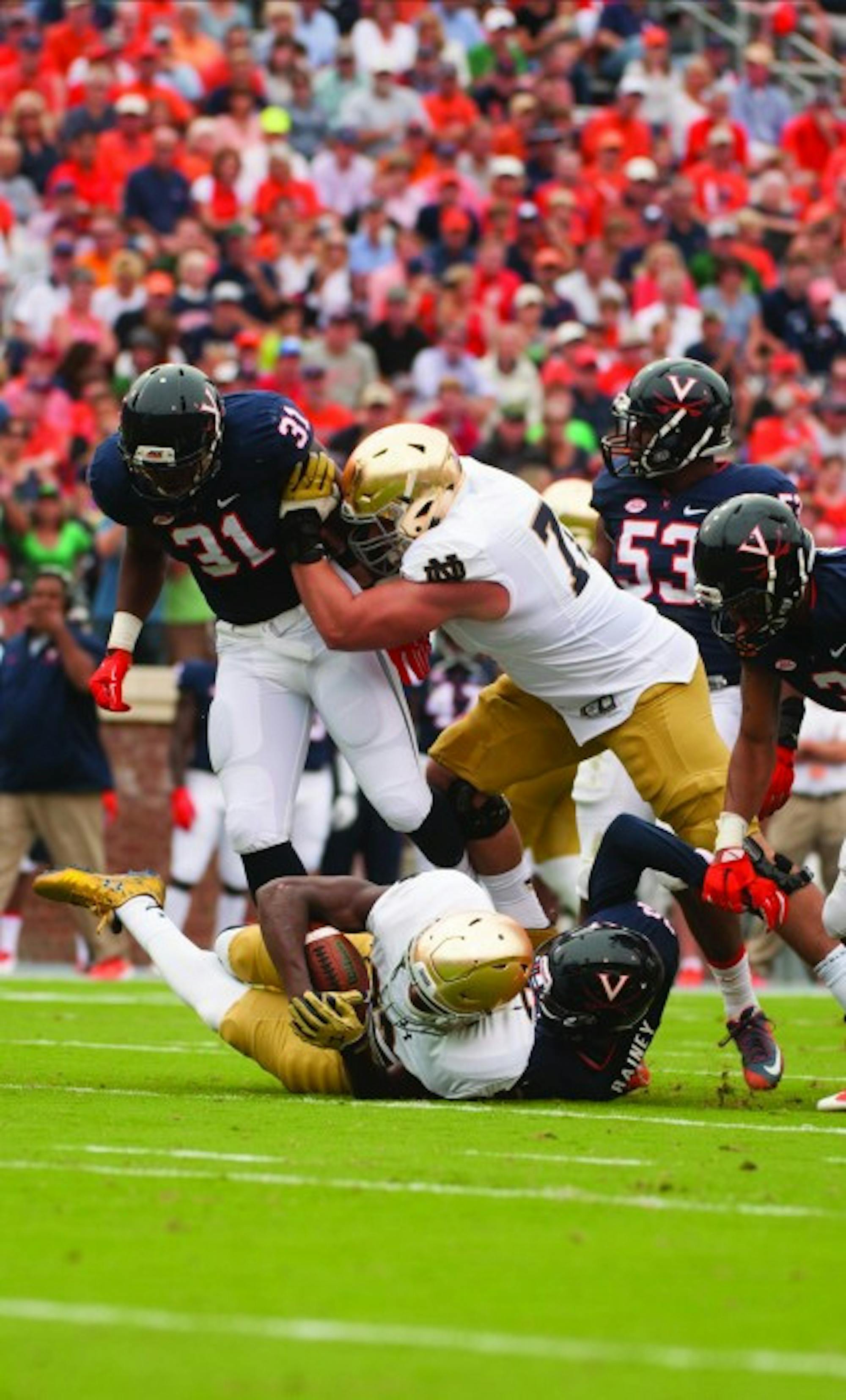 Irish graduate student offensive lineman Nick Martin makes a block during Notre Dame’s 34-27 win over Virginia on Sept. 12.