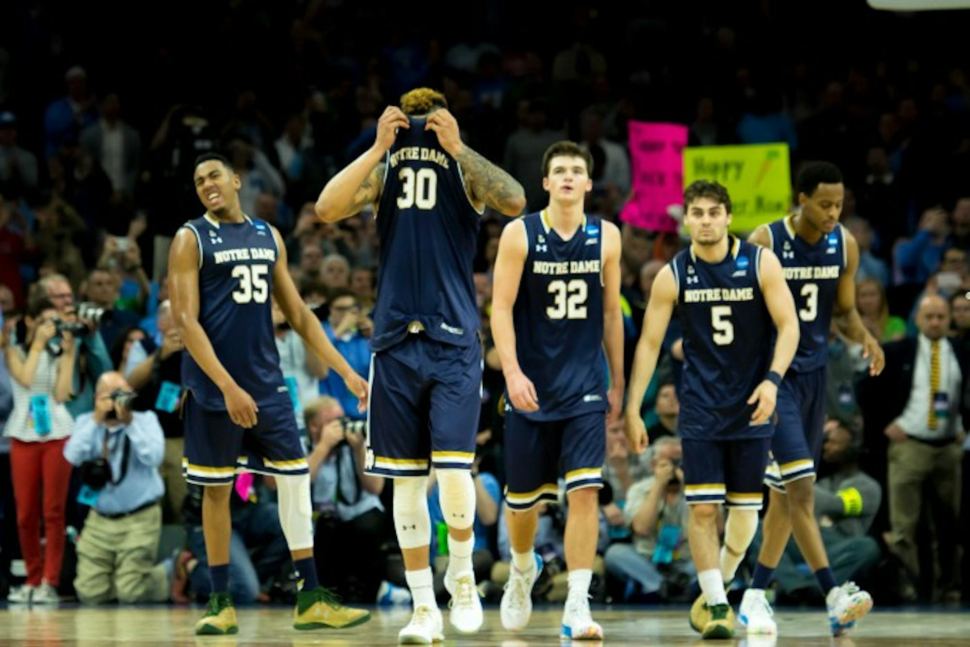 Notre Dame players look on dejectedly as the final seconds wind down of their 88-74 loss to North Carolina on Sunday in the Elite Eight.