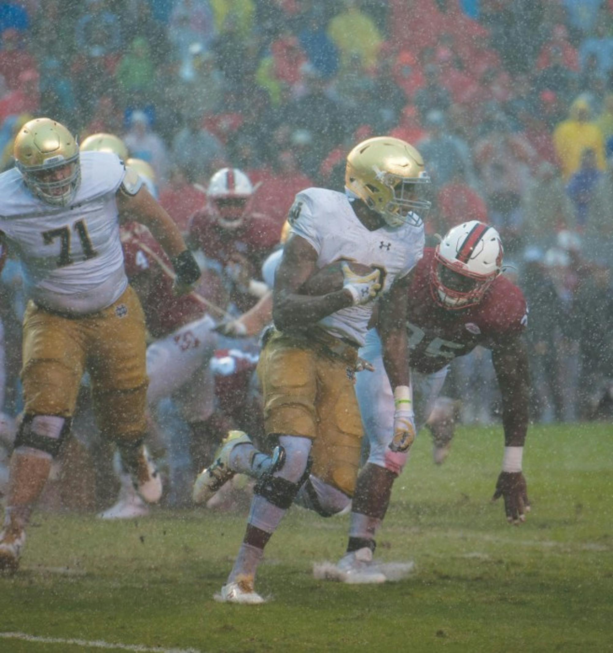 Irish sophomore running back Josh Adams runs the ball during Notre Dame’s 10-3 loss to North Carolina State on Saturday. Adams rushed for 51 yards on 14 attempts to bring his season total to 391 yards.