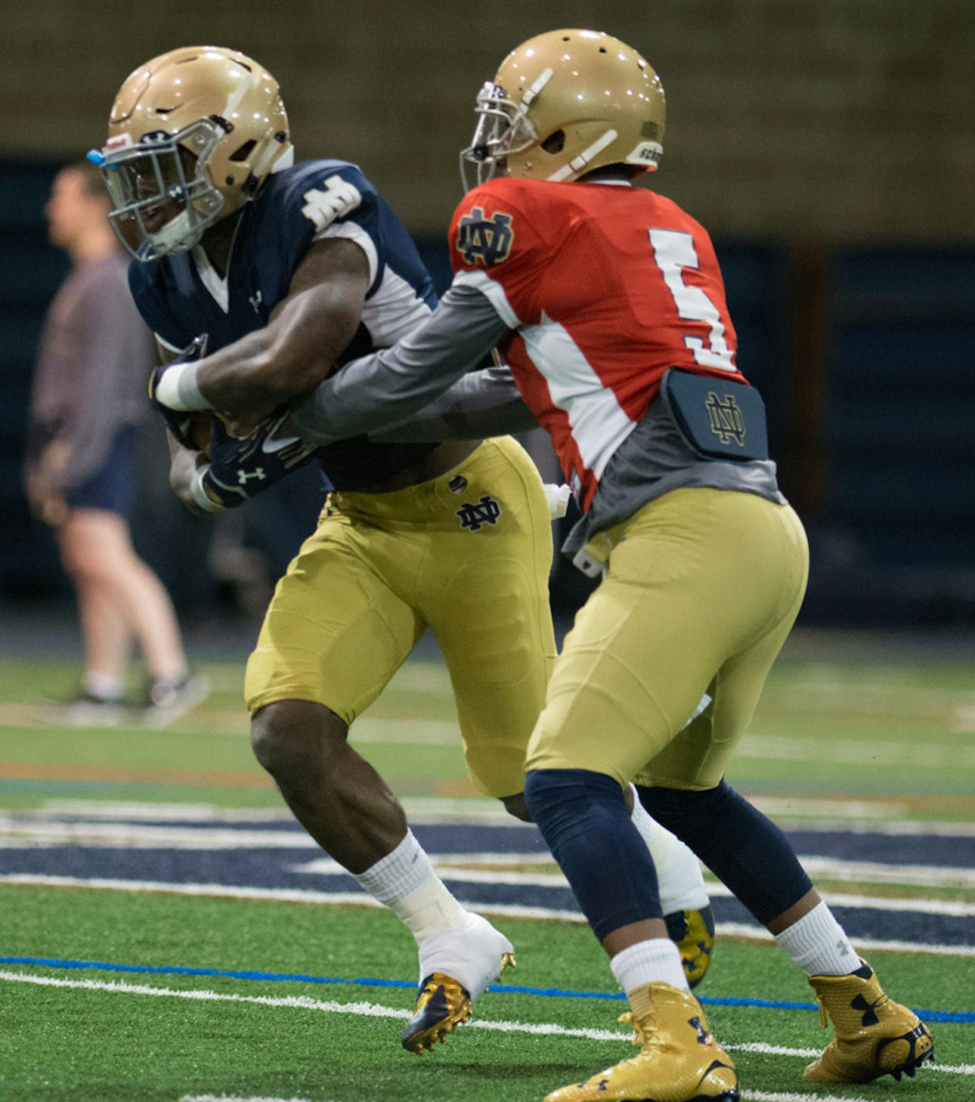 Irish graduate student quarterback Everett Golson hands the ball off to junior running back Greg Bryant during a March 27 practice.