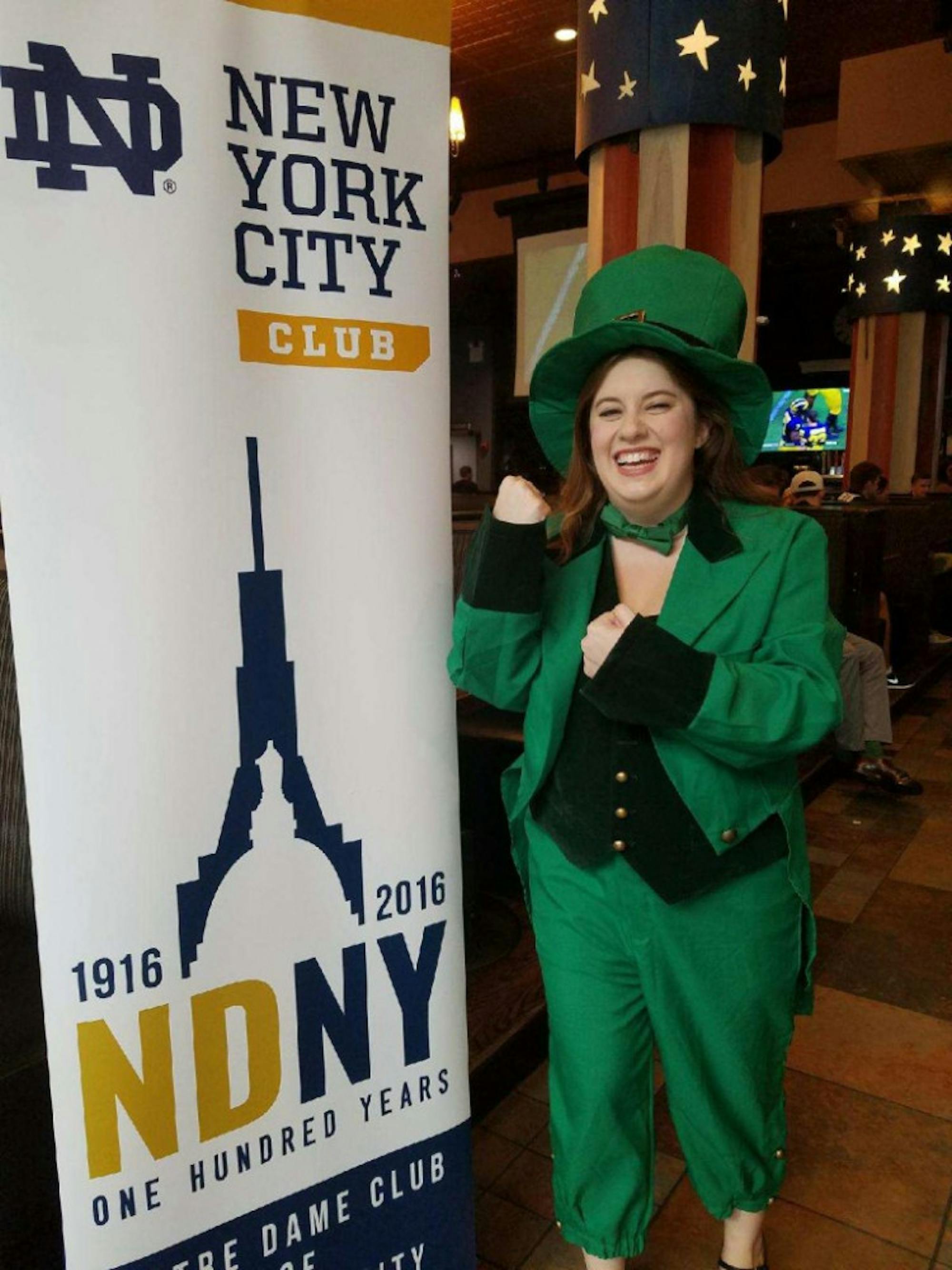 A Notre Dame alumna and member of the Notre Dame Club of New York poses in a leprechaun costume at one an NDNY game watch at the Public House.