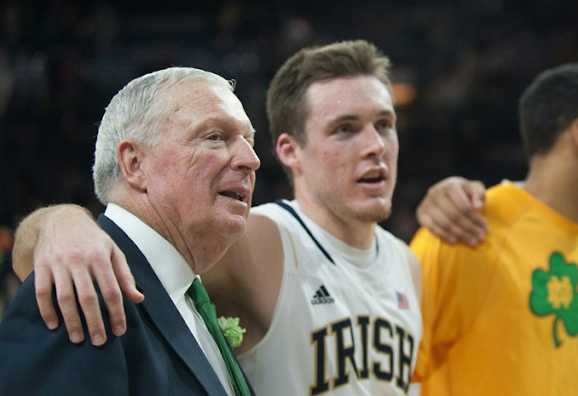 Digger Phelps, left, and Pat Connaughton sing the Alma Mater after Notre Dame's 70-63 victory over Virginia Tech on Sunday. Phelps became the sixth person and first Irish coach to enter the Ring of Honor.