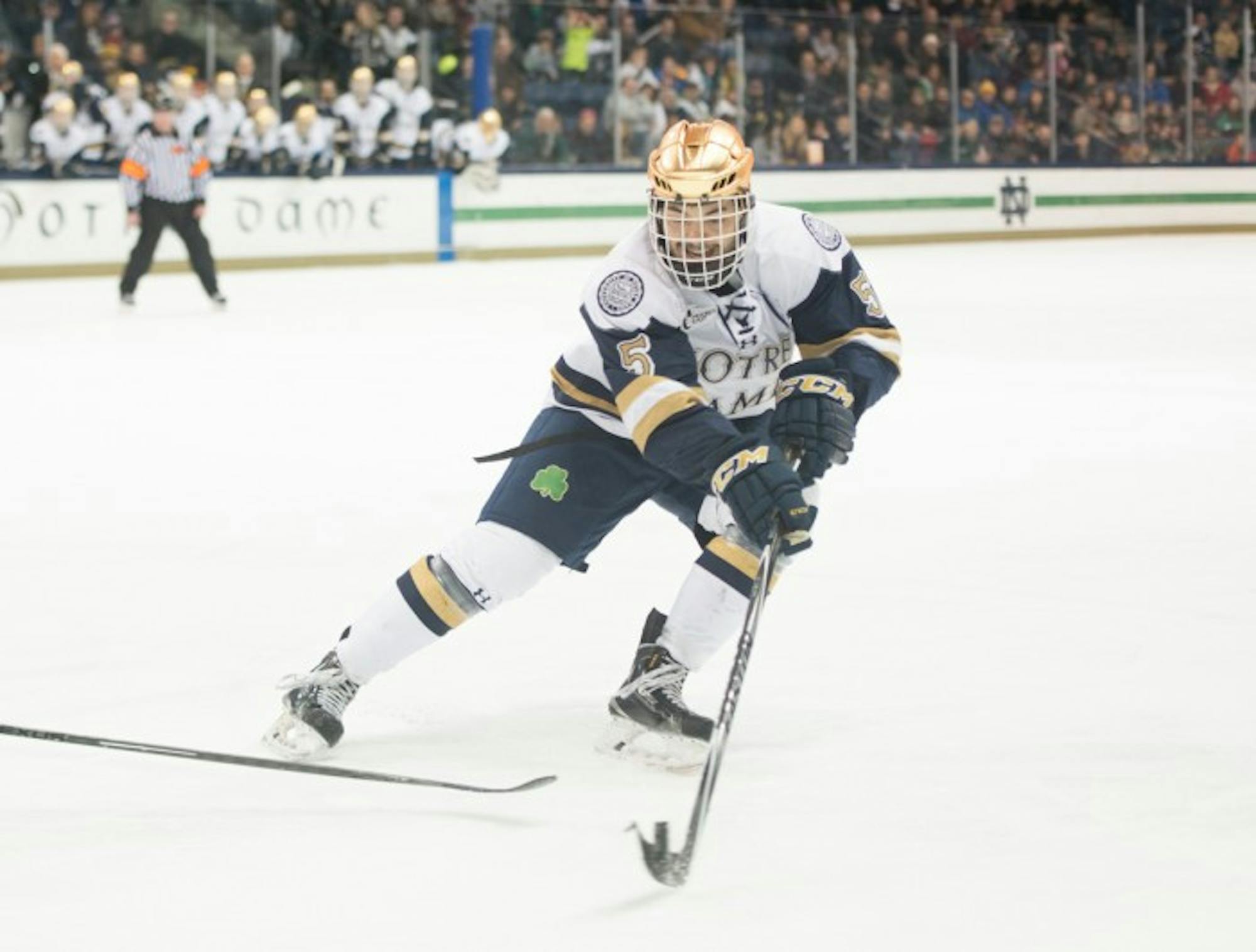Irish senior defenseman Robbie Russo tries to corral a loose puck in the offensive zone in Notre Dame’s 3-3 tie with Connecticut on Jan. 16.
