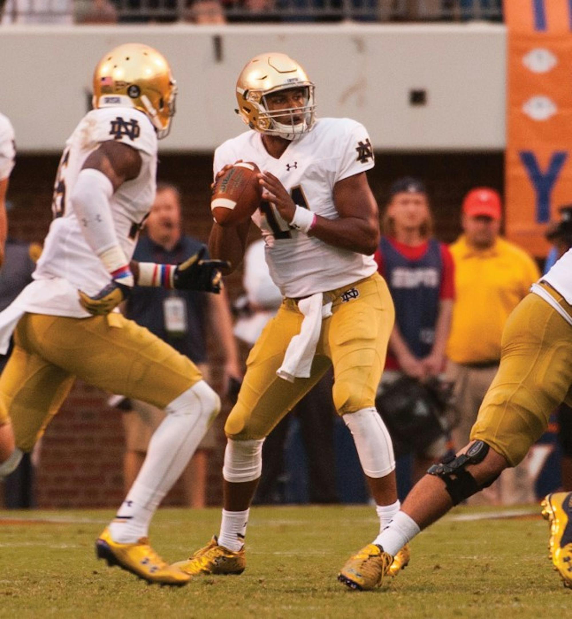 Irish quarterback DeShone Kizer drops back to pass during Notre Dame’s 34-27 win over Virginia at Scott Stadium on Saturday. The sophomore threw two touchdown passes, including the game winner.