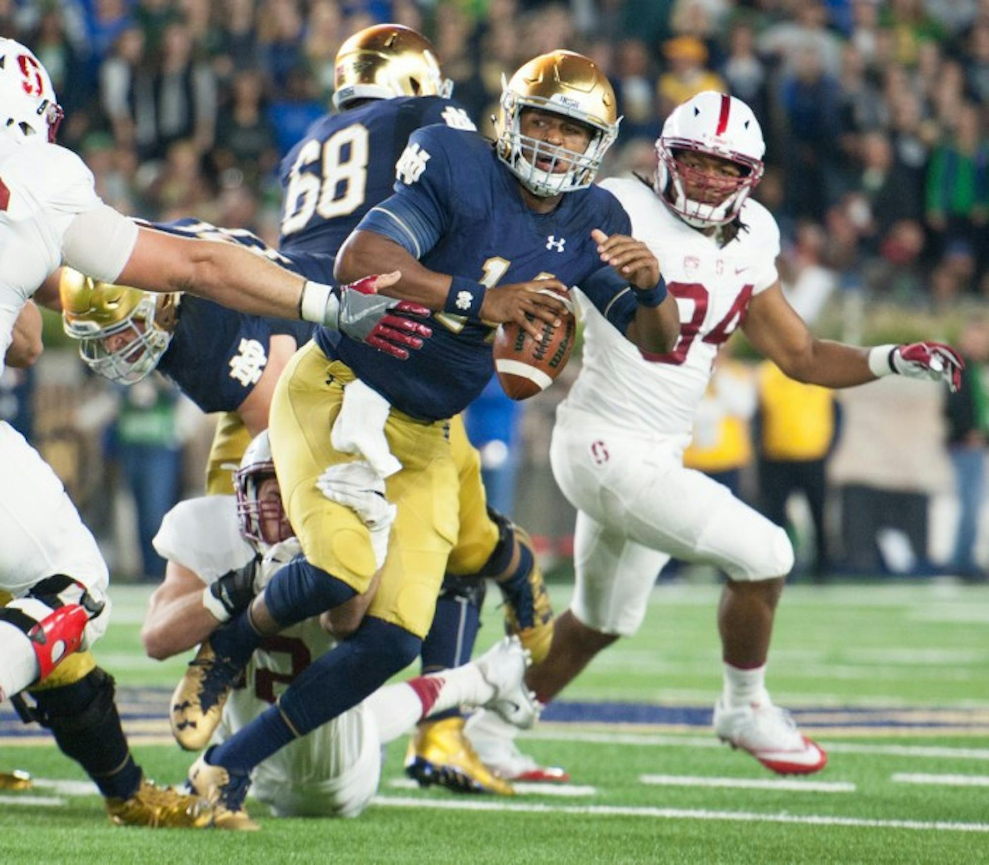 Irish junior quarterback DeShone Kizer scrambles through traffic while keeping his eyes downfield during Notre Dame’s 17-10 loss to Stanford on Oct. 15 at Notre Dame Stadium.
