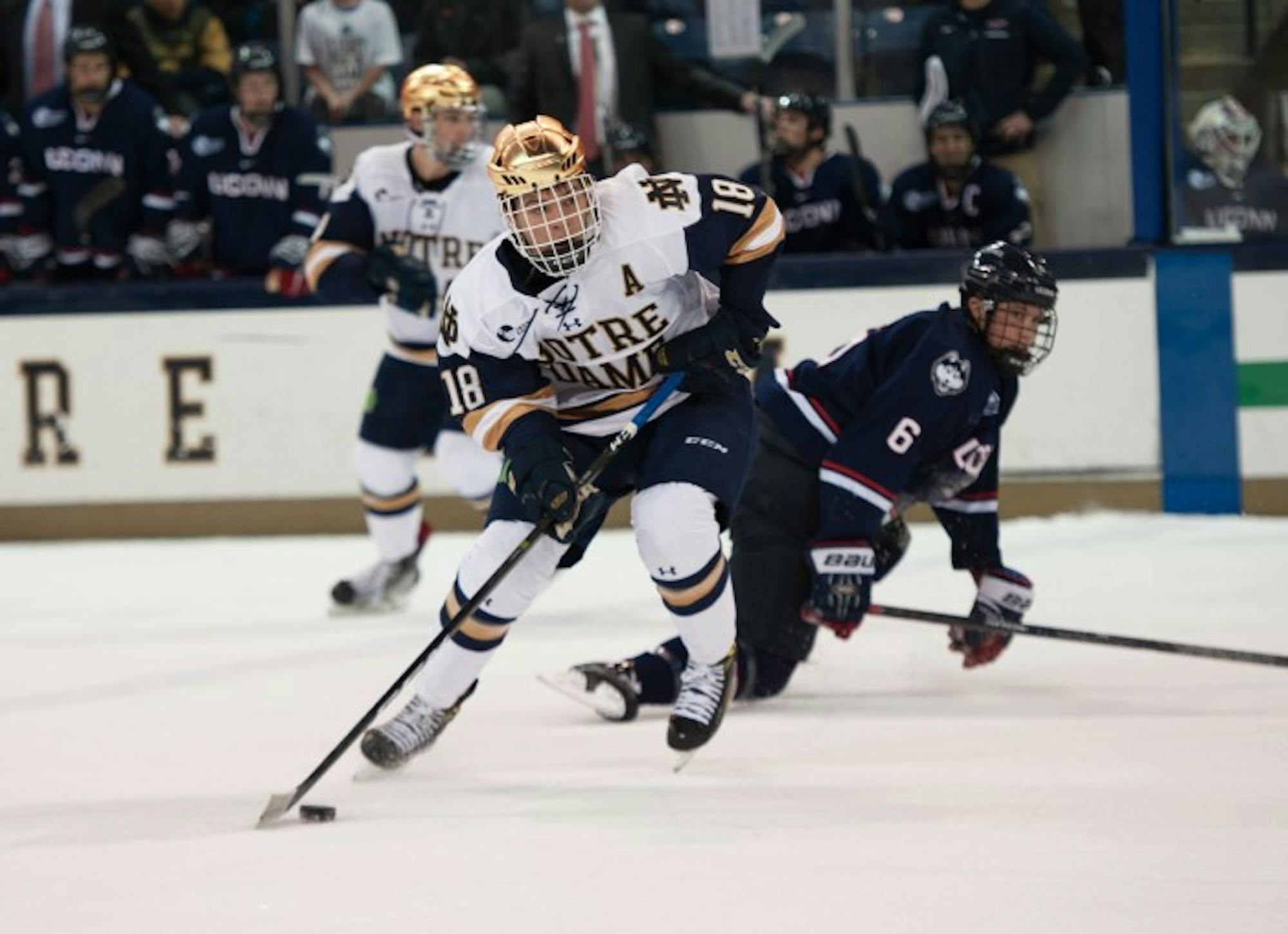 Irish junior forward Jake Evans looks up the ice during Notre Dame’s game against UConn on Oct. 27 at Compton Arena.