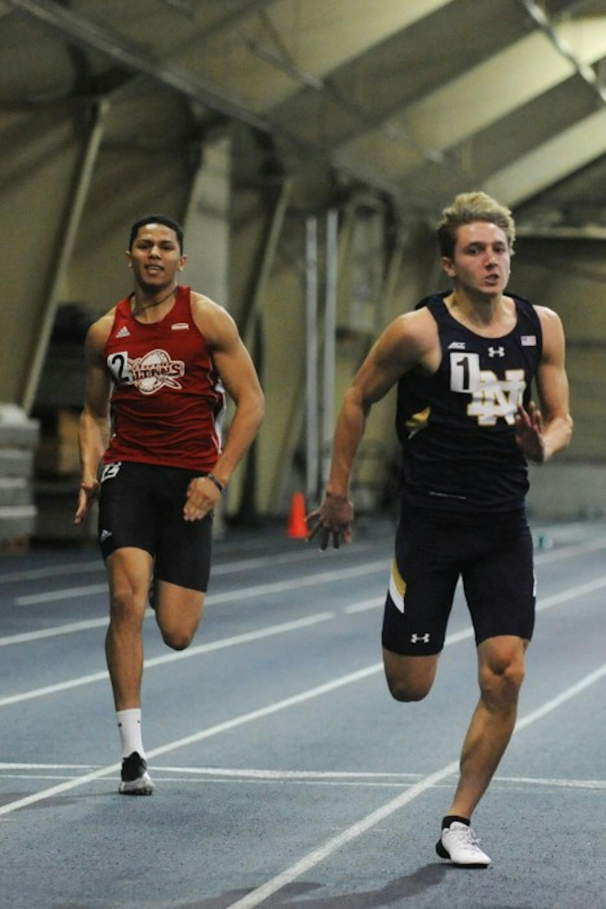 Irish sophomore Zachary Zajdel crosses the finish line in the 60-meter dash during the Blue and Gold Invitational on Friday.