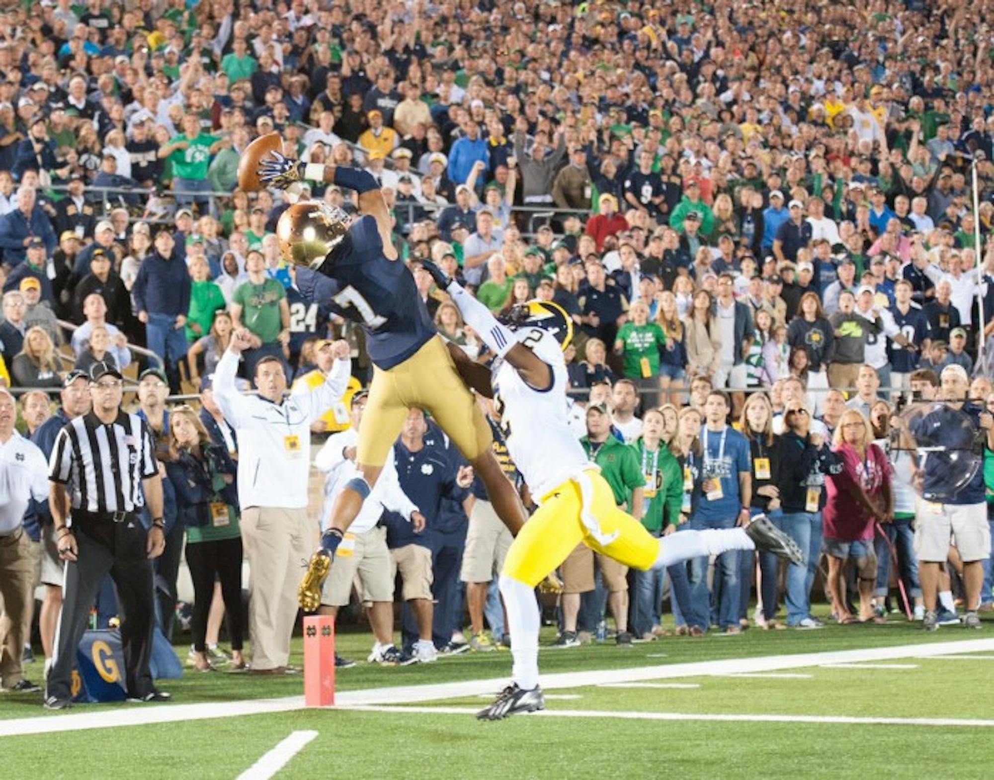 Former Irish receiver Will Fuller leaps to haul in a touchdown pass from former quarterback Everett Golson during Notre Dame’s 31-0 win over Michigan on Sept. 6, 2014 at Notre Dame Stadium.