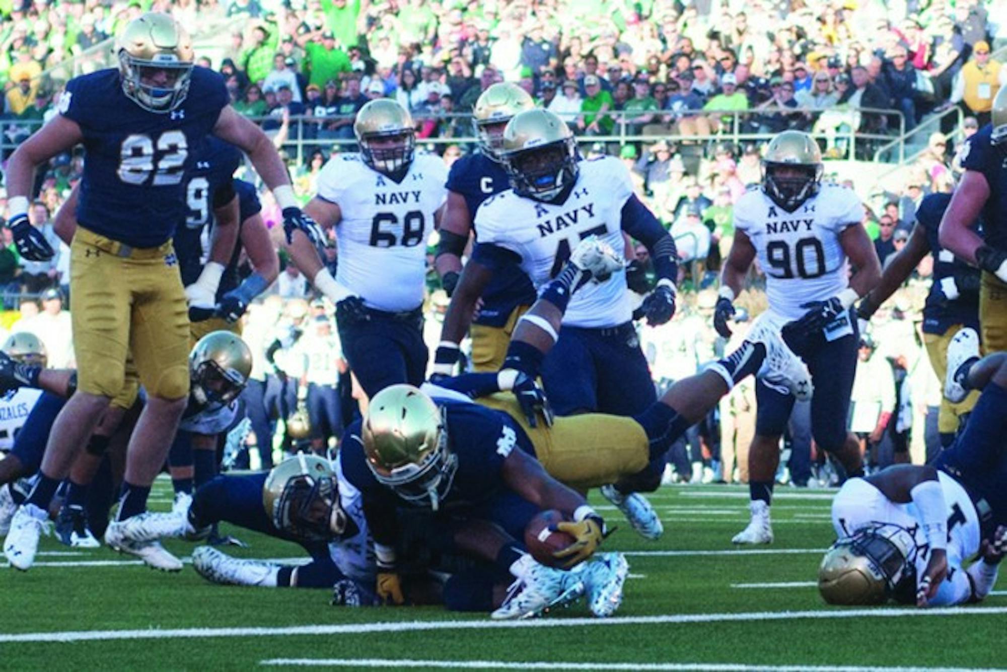 Irish senior running back C.J. Prosise stretches across the goal line for one of his three touchdowns  Saturday during Notre Dame’s 41-24 victory over Navy at Notre Dame Stadium.
