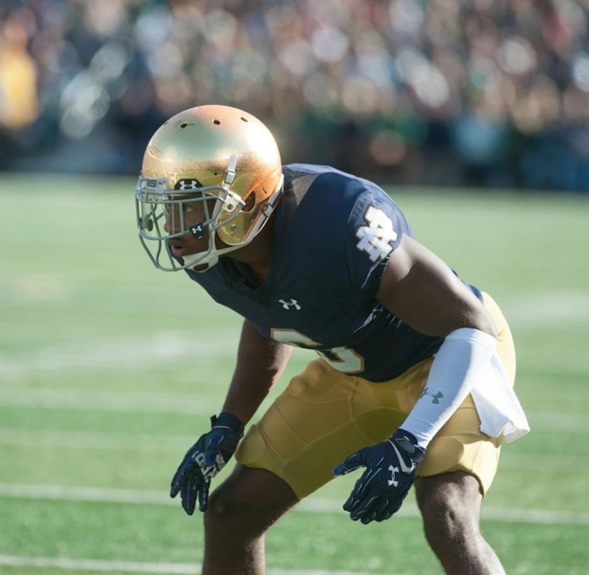 Notre Dame senior cornerback KeiVarae Russell lines up before a play as the rest those at Notre Dame Stadium is reflected off his helmet during the game Saturday.