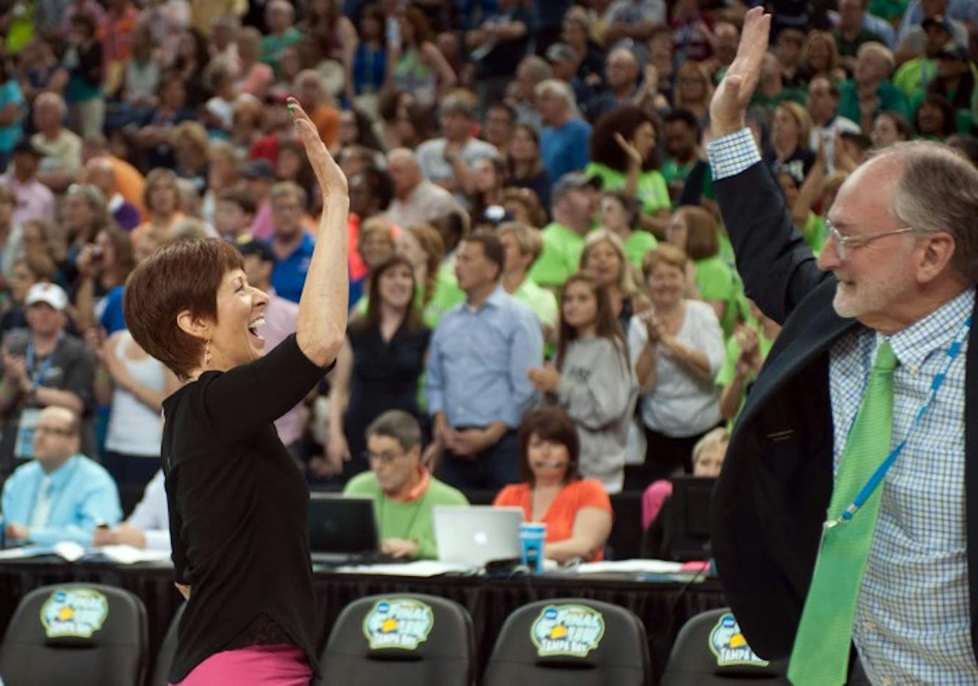 Irish head coach Muffet McGraw high-fives Director of Athletics Jack Swarbrick after Notre Dame’s last-    second, 66-65 win over South Carolina in the national semifinal April 5 at Amalie Arena in Tampa, Fla.