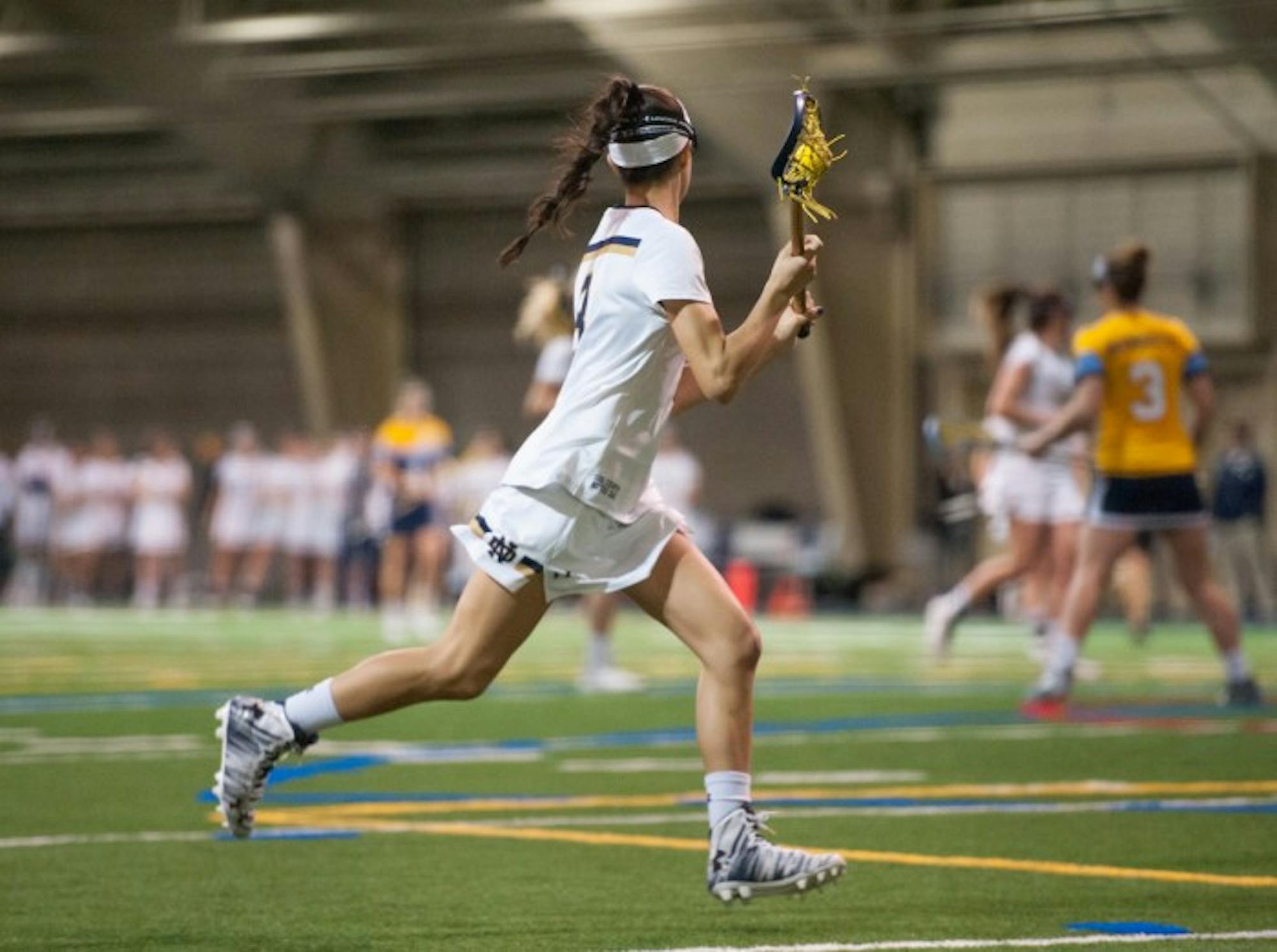 Irish sophomore attack Nikki Ortega cradles the ball during Notre Dame’s 21-9 win over Marquette on Tuesday. Ortega scored a career high seven points in the game.