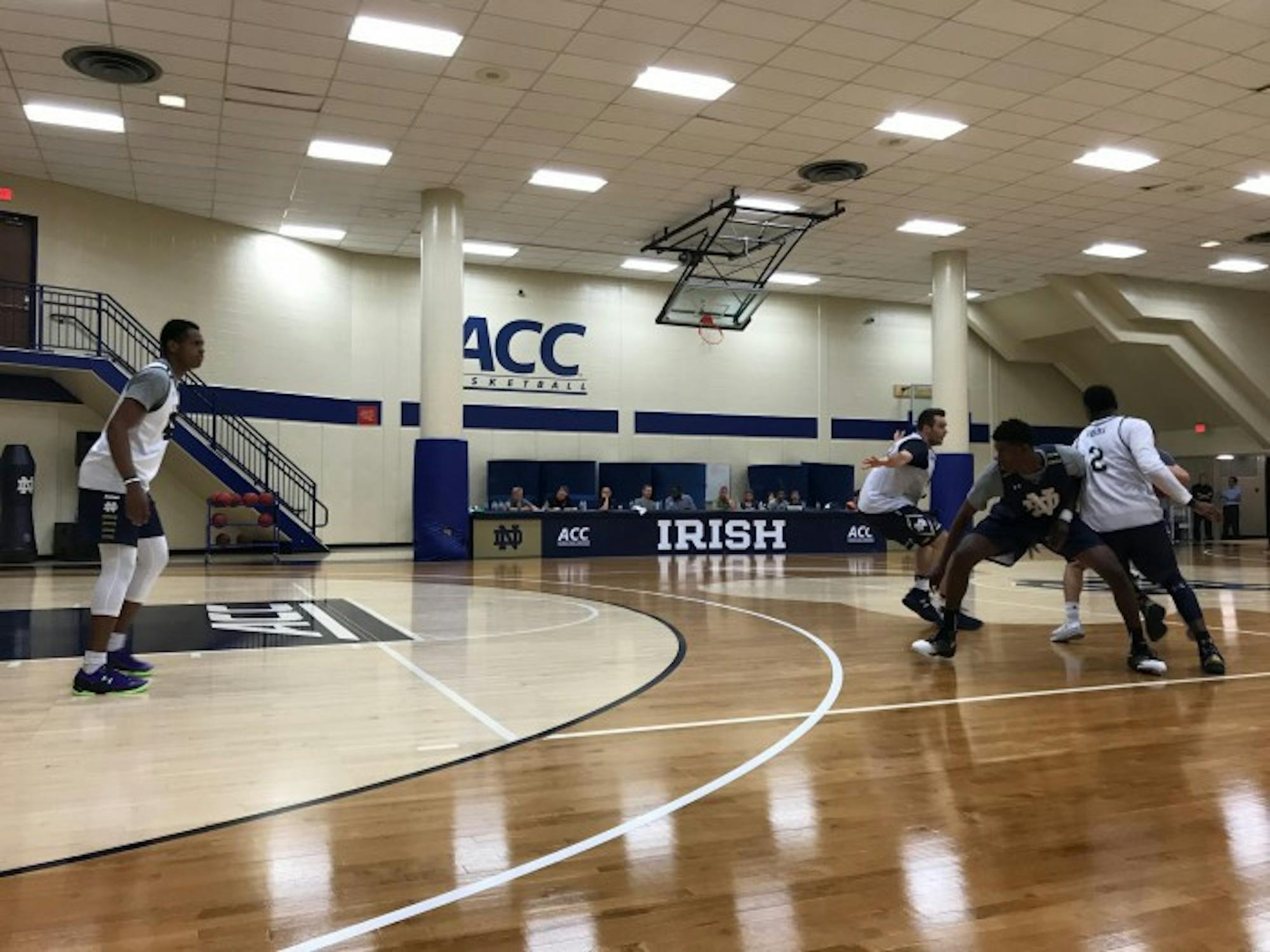 Freshman D.J. Harvey, left, hangs back to guard a pick-and-roll in a practice on July 6 at the JACC.