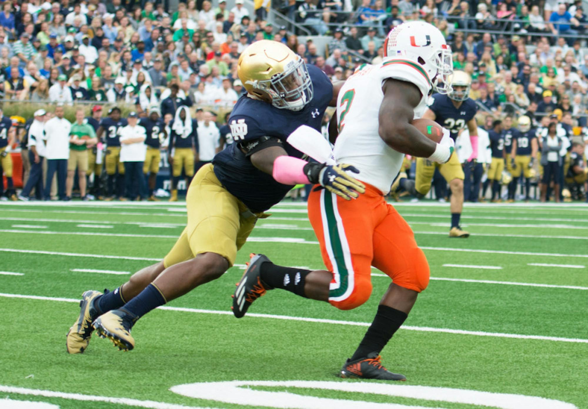 Irish senior linebacker Nyles Morgan tackles a Miami player during Notre Dame’s 30-27 win over Miami (FL) on Oct. 29, 2016, at Notre Dame Stadium. The Irish landed three linebacker commits this summer, which will fill the holes left by the graduation of Morgan and seniors Drue Tranquill and Greer Martini after this season.