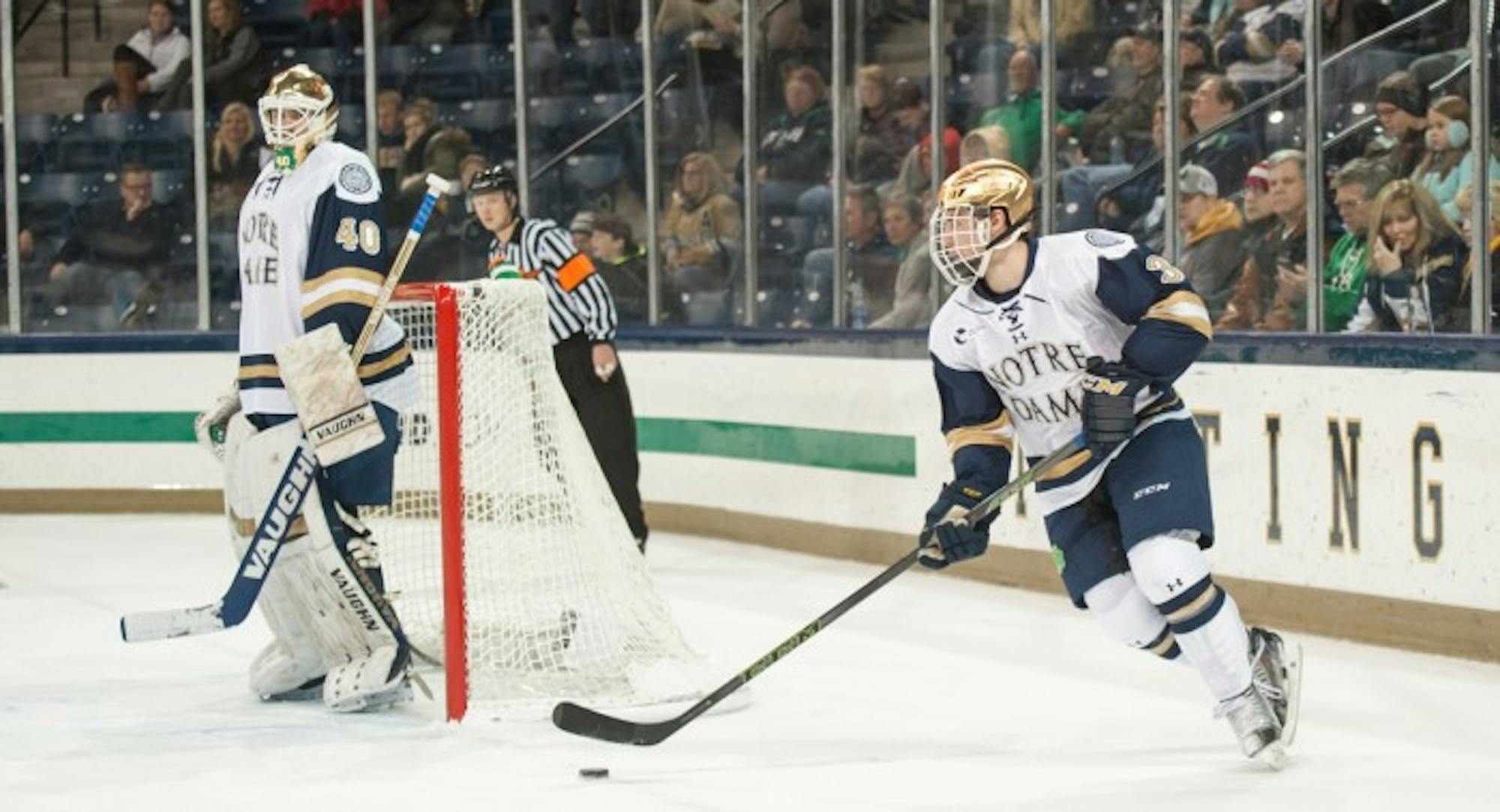 Sophomore defenseman Jordan Gross regroups behind the Notre Dame net during the 3-2 Irish victory over Northeastern on Nov. 12 at Compton Family Ice Arena. Gross had four shots in Friday’s tie.