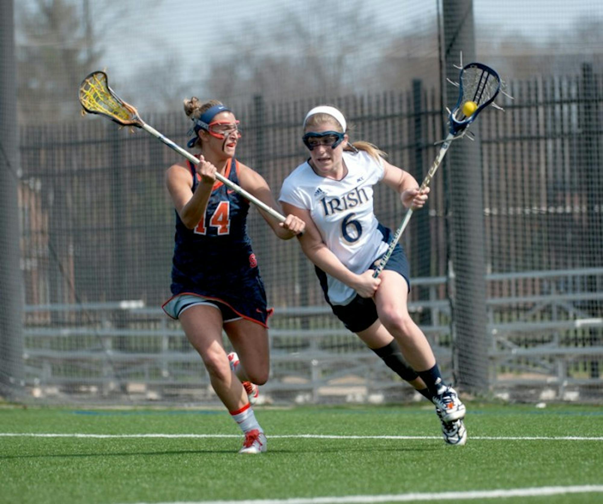 Sophomore attack Stephanie Toy tries to evade Syracuse senior      defender Kasey Mock in the teams’ first meeting of the year April 19.