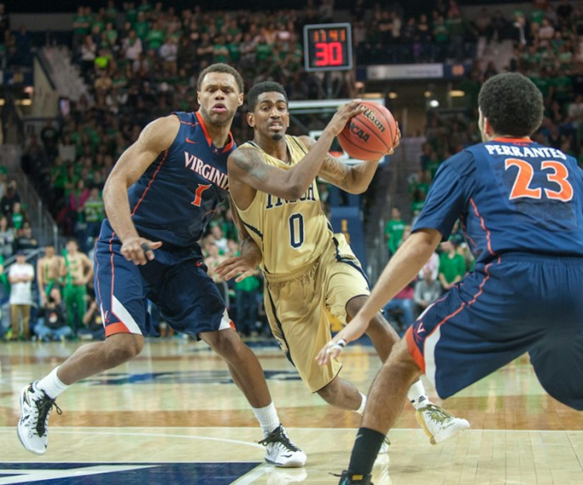 Irish senior guard Eric Atkins drives into the lane during Notre Dame’s 68-53 loss to Virginia on Tuesday. Atkins scored six points, and the two leaders on the night for the Irish netted 10 each.