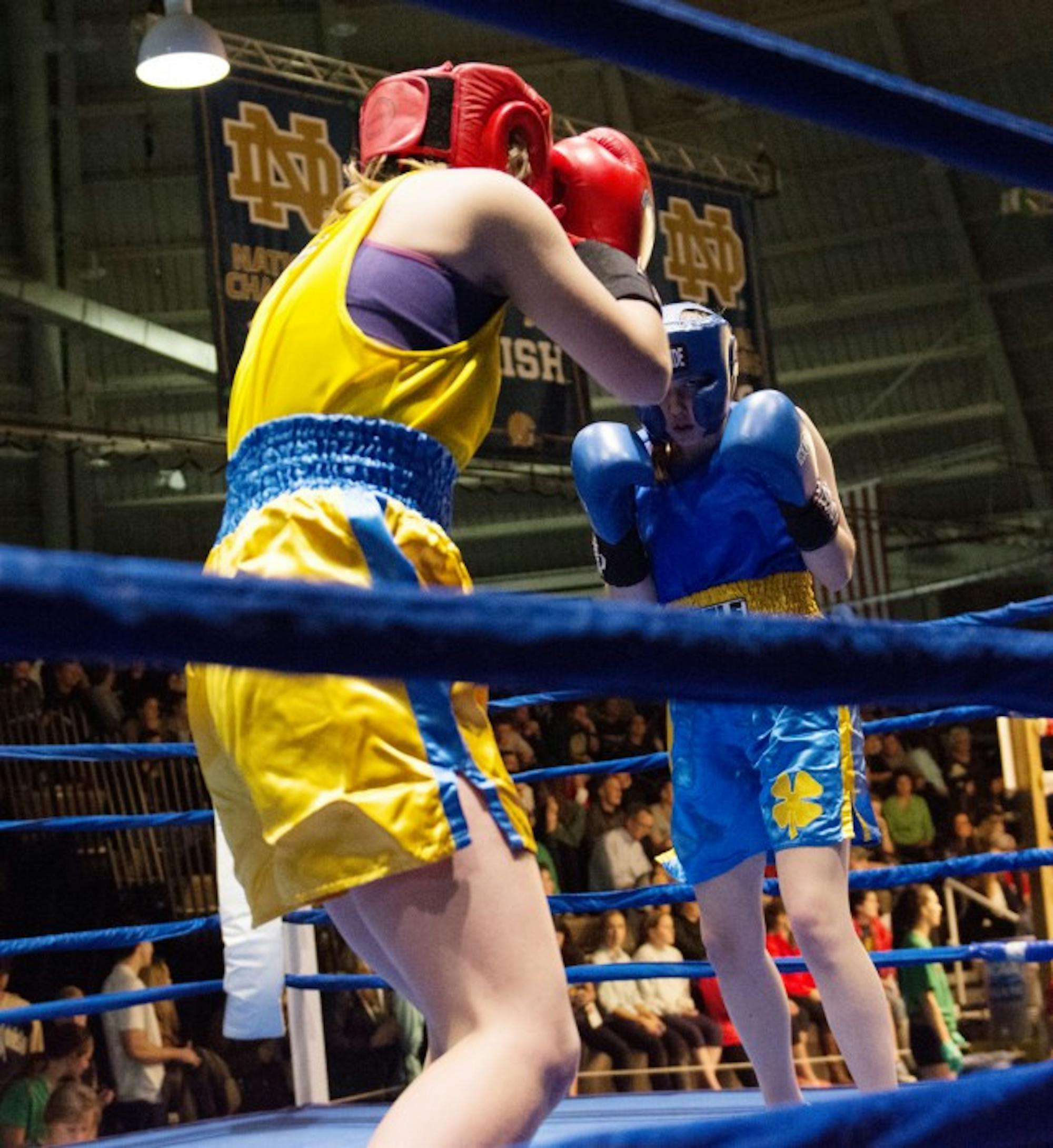 Junior Shannon Bugos, right, stares down sophomore Ellen McCourt during their semifinal bout Tuesday night at Joyce Center Fieldhouse. Bugos won the fight by unanimous decision.