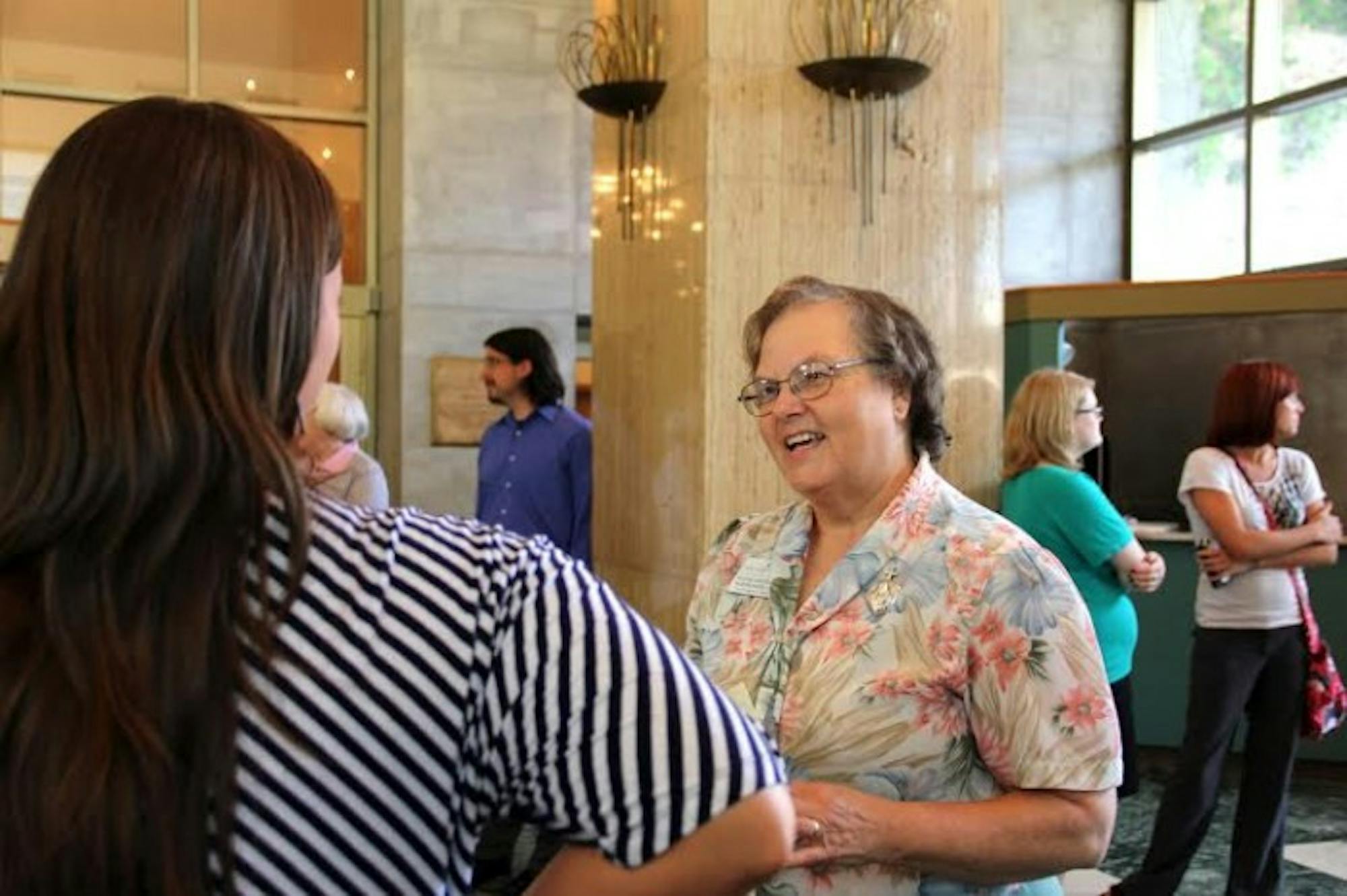 Sister Veronique Wiedower speaks with faculty and staff as her farewell part in the lobby of O'Laughin Auditorium on Wednesday. Wiedower has been at the College since 2011 and is an alum.