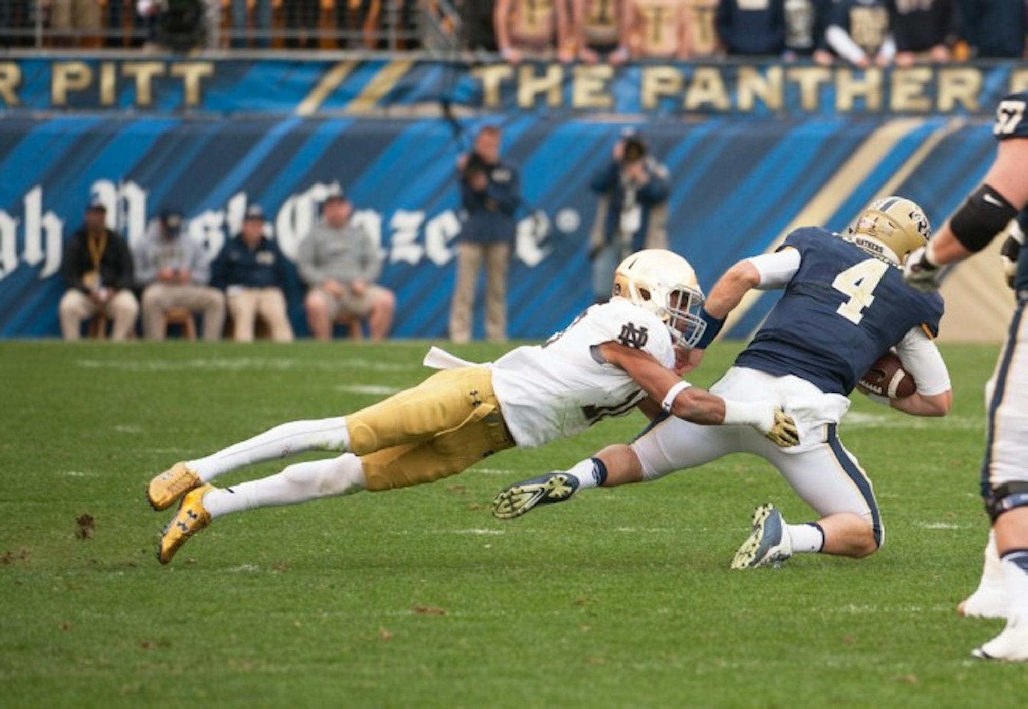 Irish senior safety Max Redfield takes down Pittsburgh quarterback Nate Peterman during Notre Dame’s 42-30 win over the Panthers at Heinz Field in Pittsburgh. Redfield, who missed the Fiesta Bowl defeat to Ohio State after violating team rules, is one of five returning starters for the Irish on defense heading into the 2016 season.