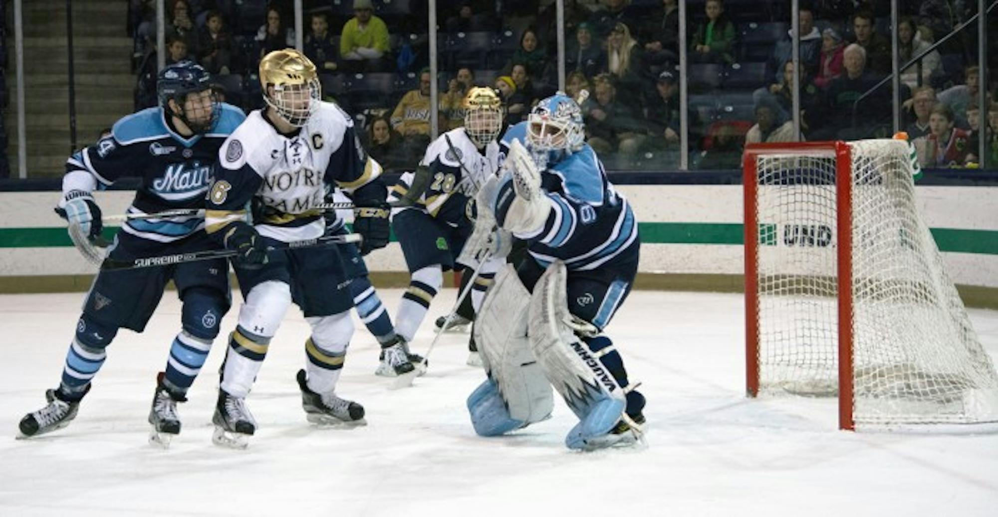 Irish senior captain Steven Fogarty crashes the net during Notre Dame’s 5-1 win over Maine on Feb. 13 at Compton Family Ice Arena.