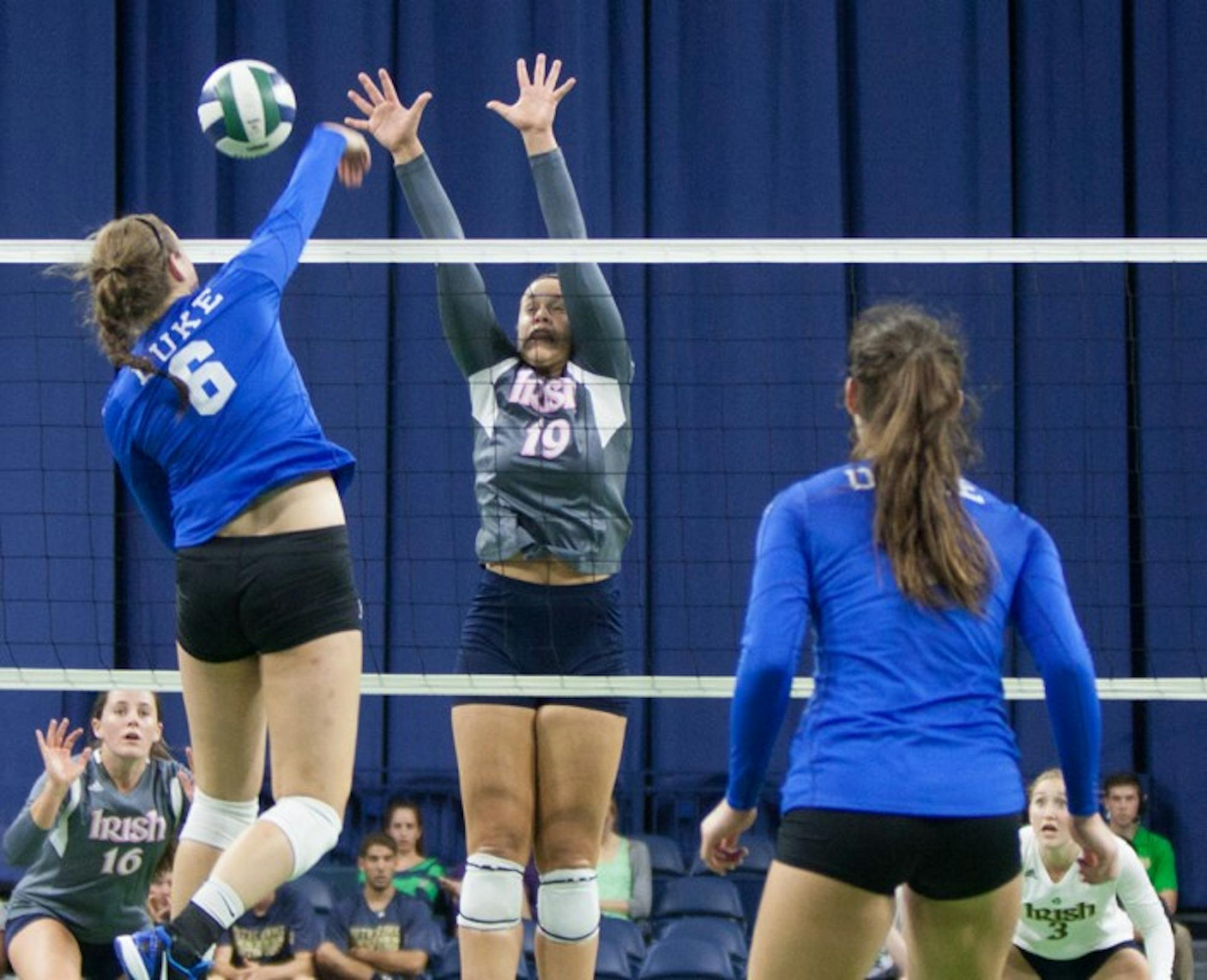 Notre Dame senior middle blocker Jeni Houser tries to get a piece of a kill attempt during a match against Duke on .  Houser leads the Irish in kills so far this season.