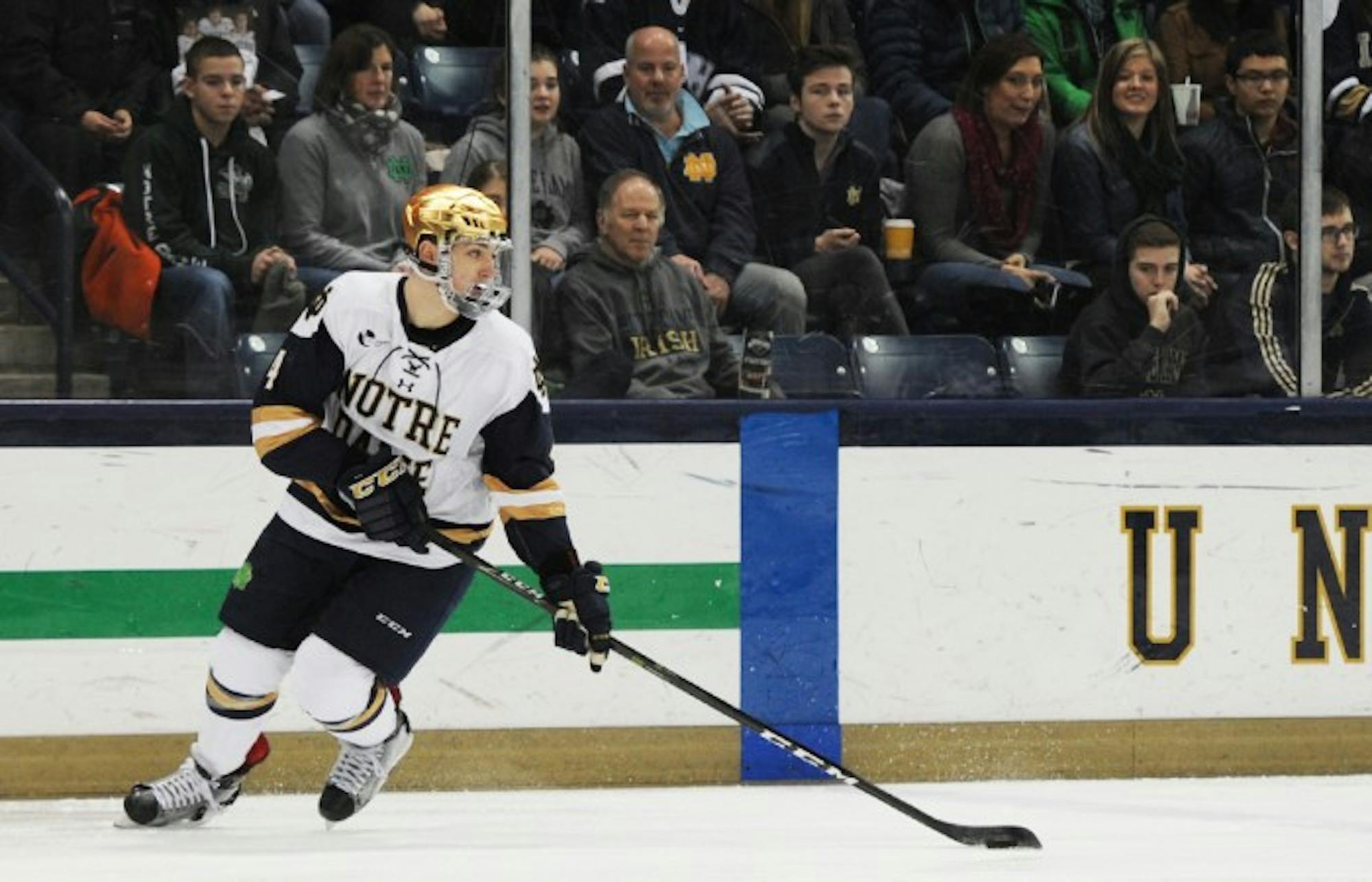 Irish sophomore defenseman Dennis Gilbert looks to move the puck during Notre Dame’s 2-2 tie in overtime against New Hampshire on Jan. 20.