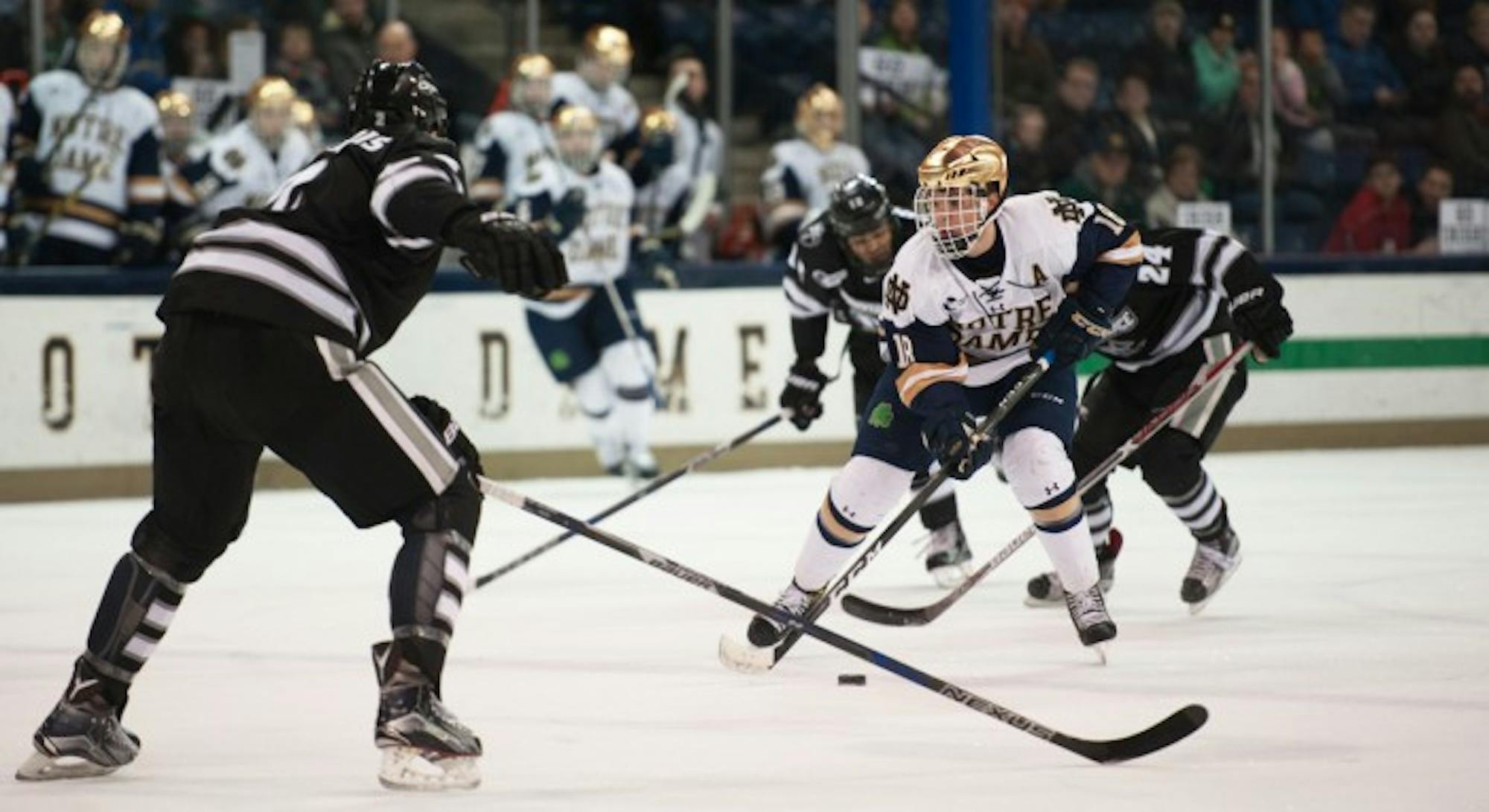 Irish senior forward Jake Evans faces a defender during Notre Dame’s 5-2 victory over Providence at Compton Family Ice Arena on Mar. 11. Evans finished last season with 13 goals and 29 assists for a total of 42 points in 40 games. Evans earned the second most points on the team, behind Anders Bjork, who graduated and now plays for the Boston Bruins.