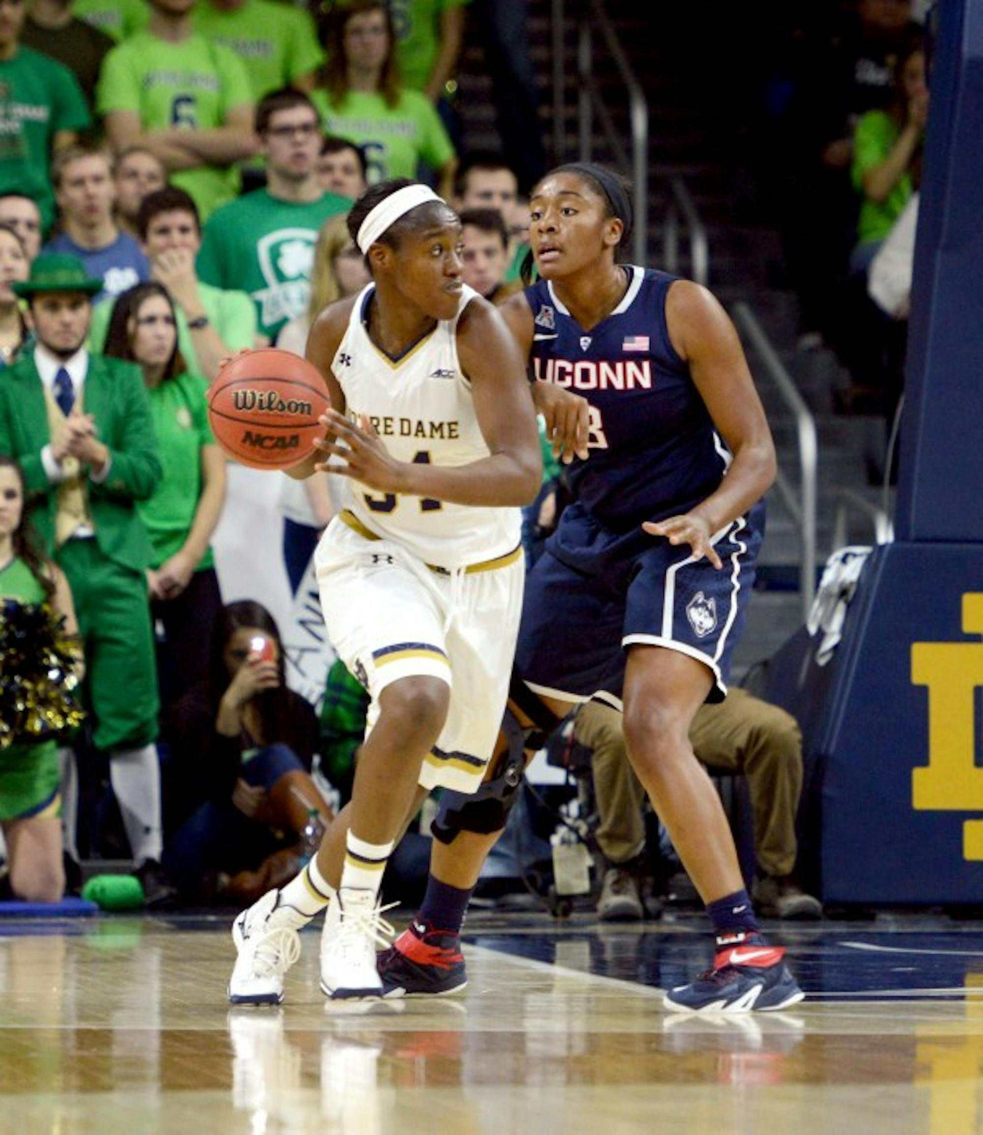 Irish senior forward Markisha Wright dribbles around a Connecticut defender during Notre Dame's 76-58 loss to the Huskies on Saturday in the Purcell Pavilion.