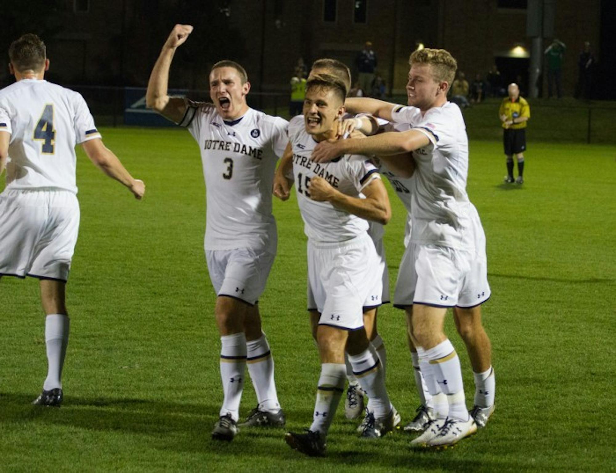 Members of the men’s soccer team celebrate a goal during a 3-1 win against Virginia on Sept. 25 at Alumni Stadium.