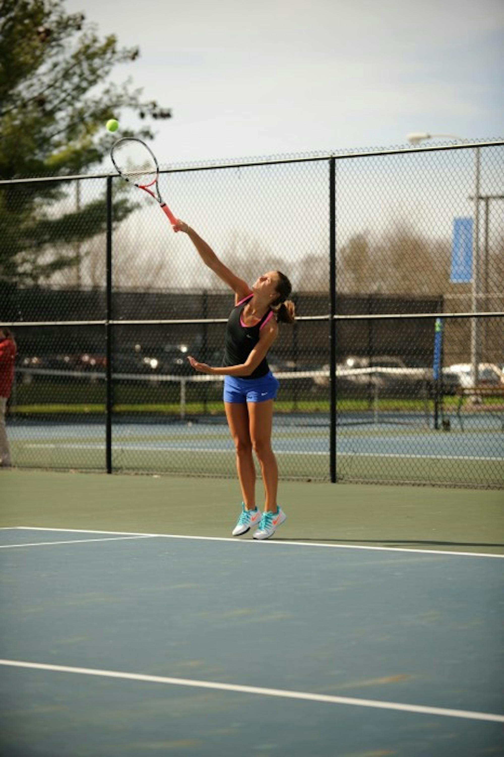 Belles senior Kayle Sexton starts a rally during Saint Mary’s 8-1 win over Adrian on April 14 at Saint Mary’s Tennis Courts.