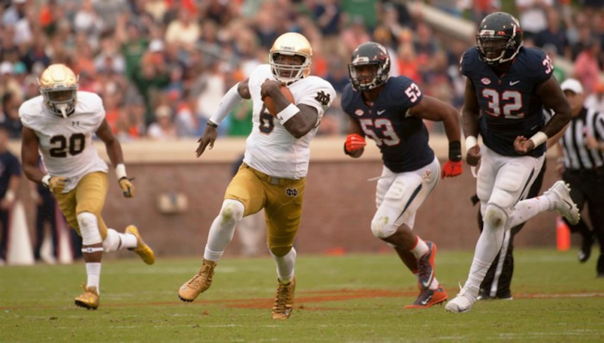 Irish senior quarterback Malik Zaire carries the ball during Notre Dame’s 34-27 win at Virginia on Sept. 12 at Scott Stadium. Zaire, who won the starting job last season, fractured his ankle in the victory.