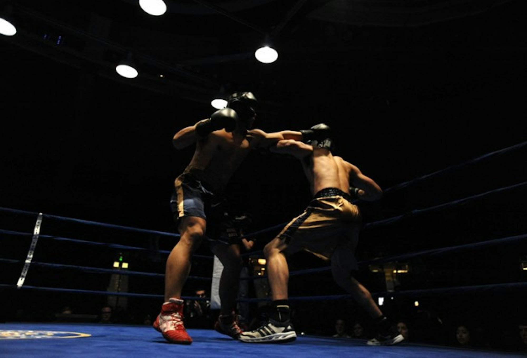 Senior captain Daniel Yi (left) lands a jab to Mike Broghammer's head in the 2013 Bengal Bouts heavyweight final March 1, which Yi won by knock out.