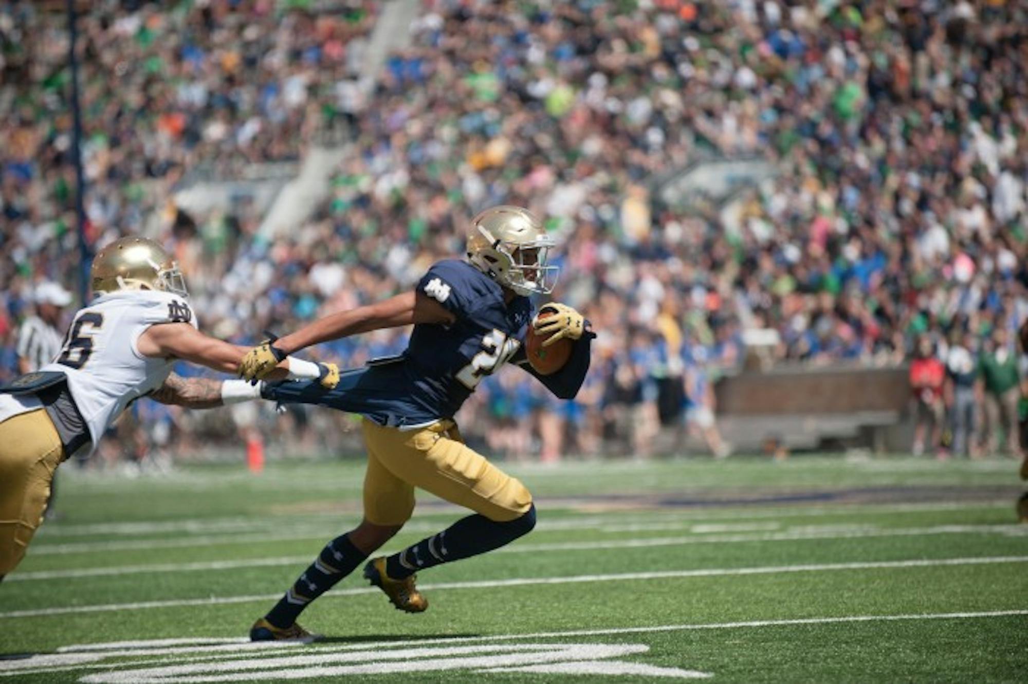 Freshman receiver Kevin Stepherson tries to break away from a defender during Notre Dame's Blue-Gold Game on Saturday at Notre Dame Stadium.