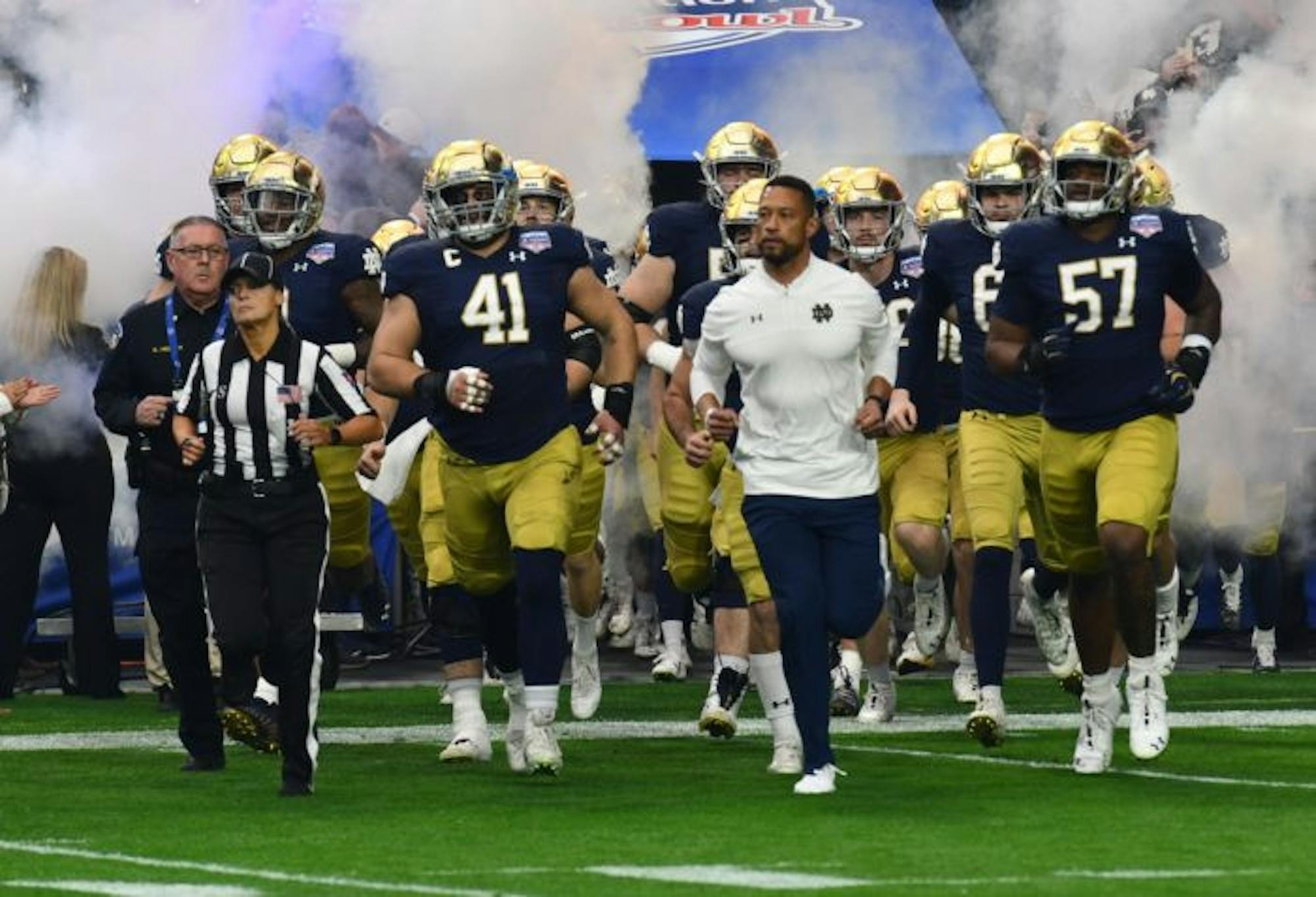 Marcus Freeman leads the Notre Dame out on the field at the Fiesta Bowl.