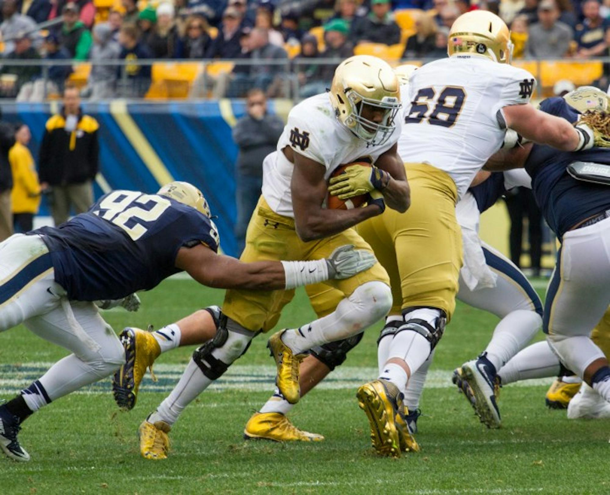 Freshman Josh Adams breaks through the line during Notre Dame’s 42-30 win over Pittsburgh on Saturday at Heinz Field. Adams rushed for 147 yards on 20 touches to lead the Irish ground game.