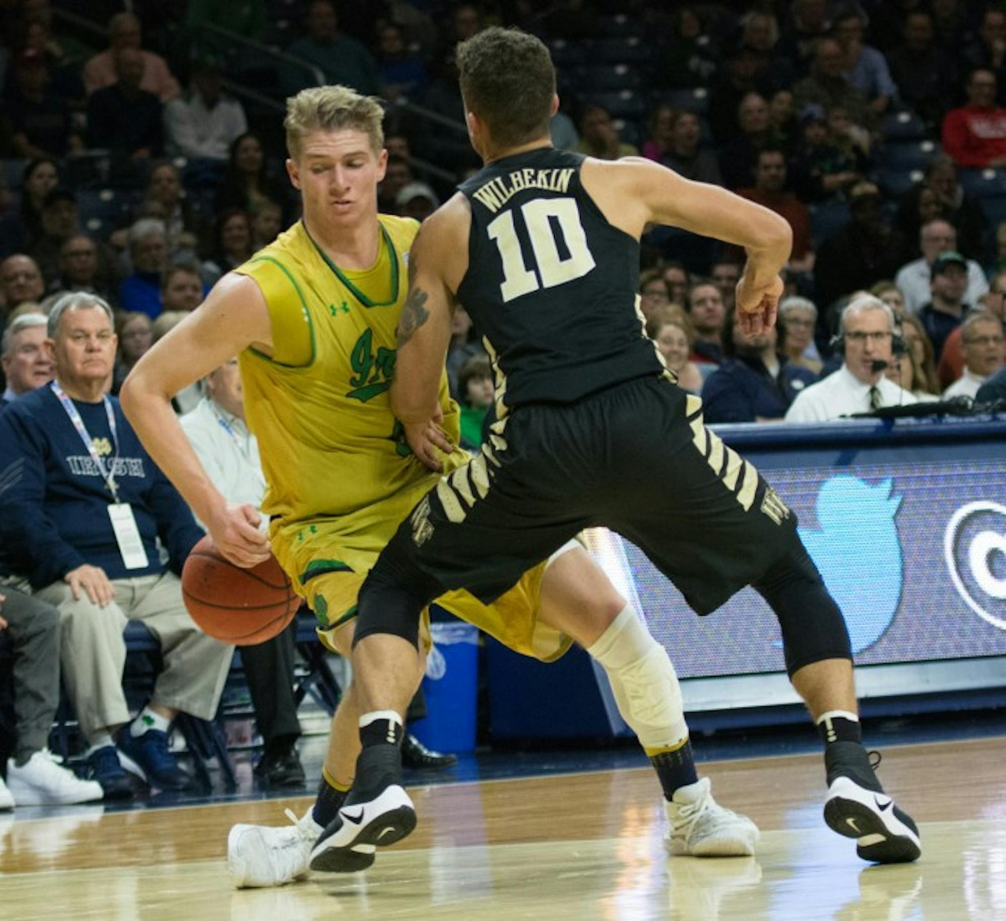 Irish sophomore guard Rex Pflueger looks to drive past a Demon Deacon defender during Notre Dame’s 88-81 win over Wake Forest on Tuesday at Purcell Pavilion.
