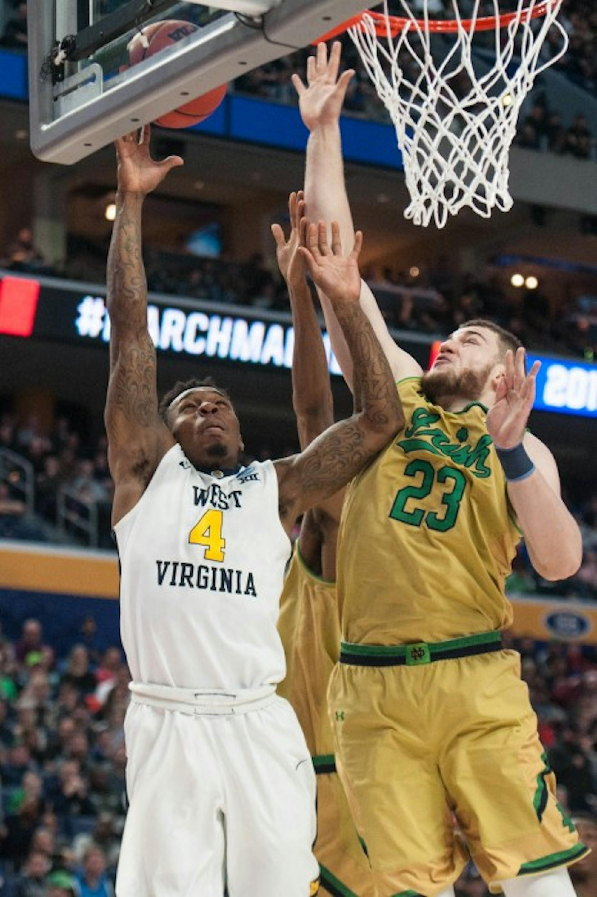 Irish junior forward Martinas Geben blocks a West Virginia player's shot during Notre Dame's 83-71 loss to the Mountaineers on Saturday at KeyBank Arena.