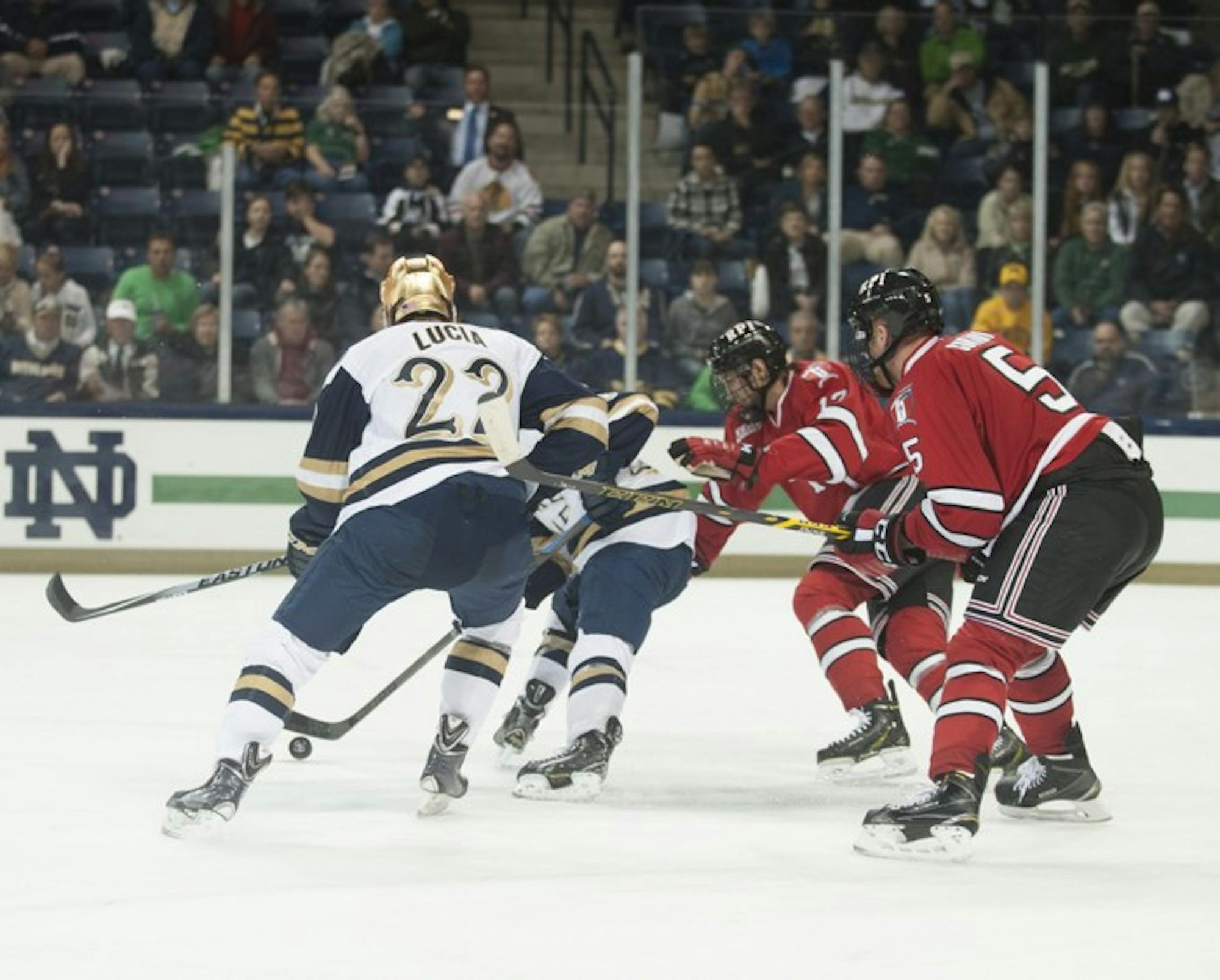 Irish junior left wing Mario Lucia tangles with defenders during Notre Dame’s 3-2 loss to Rensselaer on Oct. 10.
