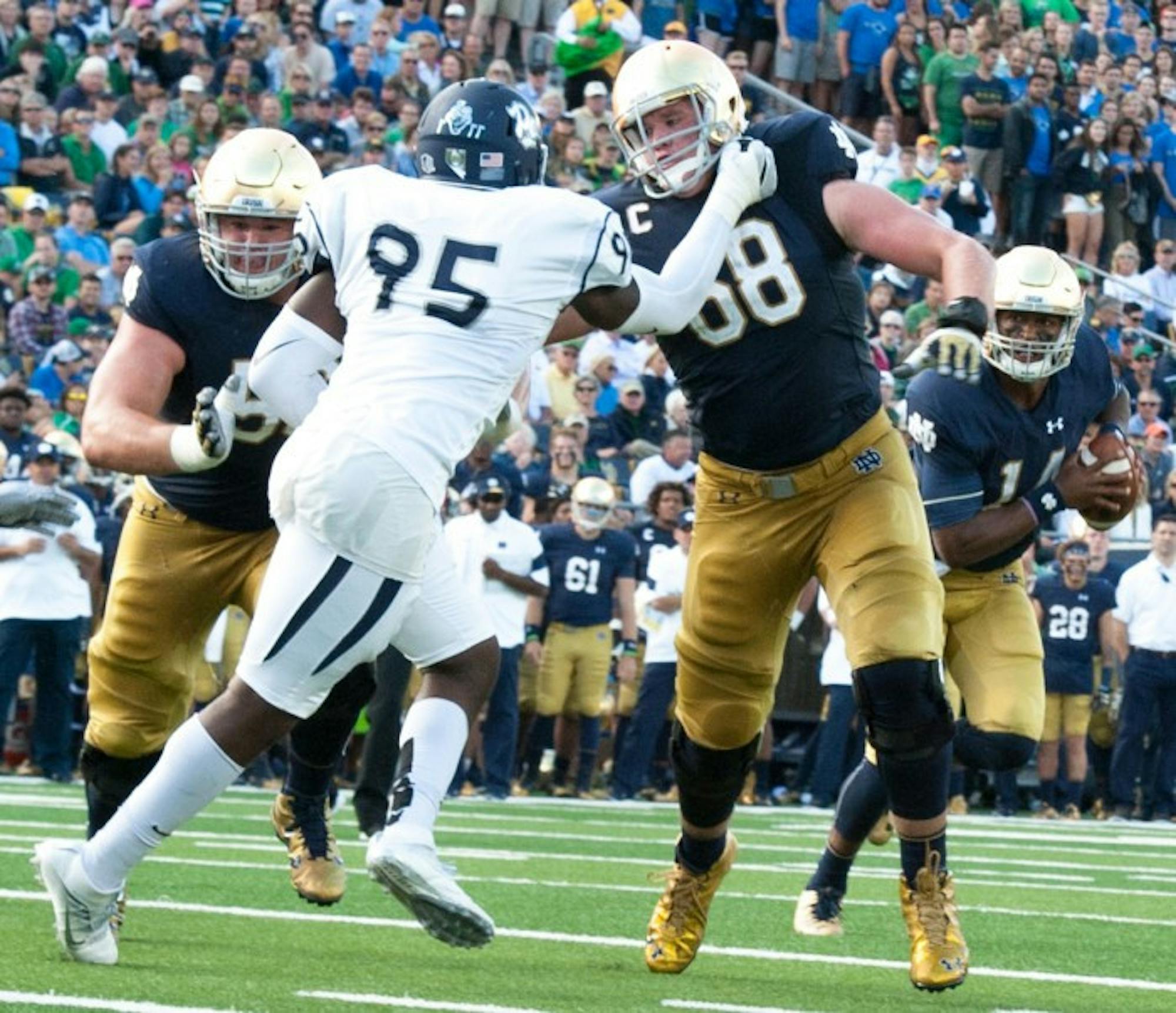 Irish senior offensive lineman and team captain Mike McGlinchey leads the way on senior running back Tarean Folston’s touchdown run late in the second quarter during Notre Dame’s victory over Nevada.
