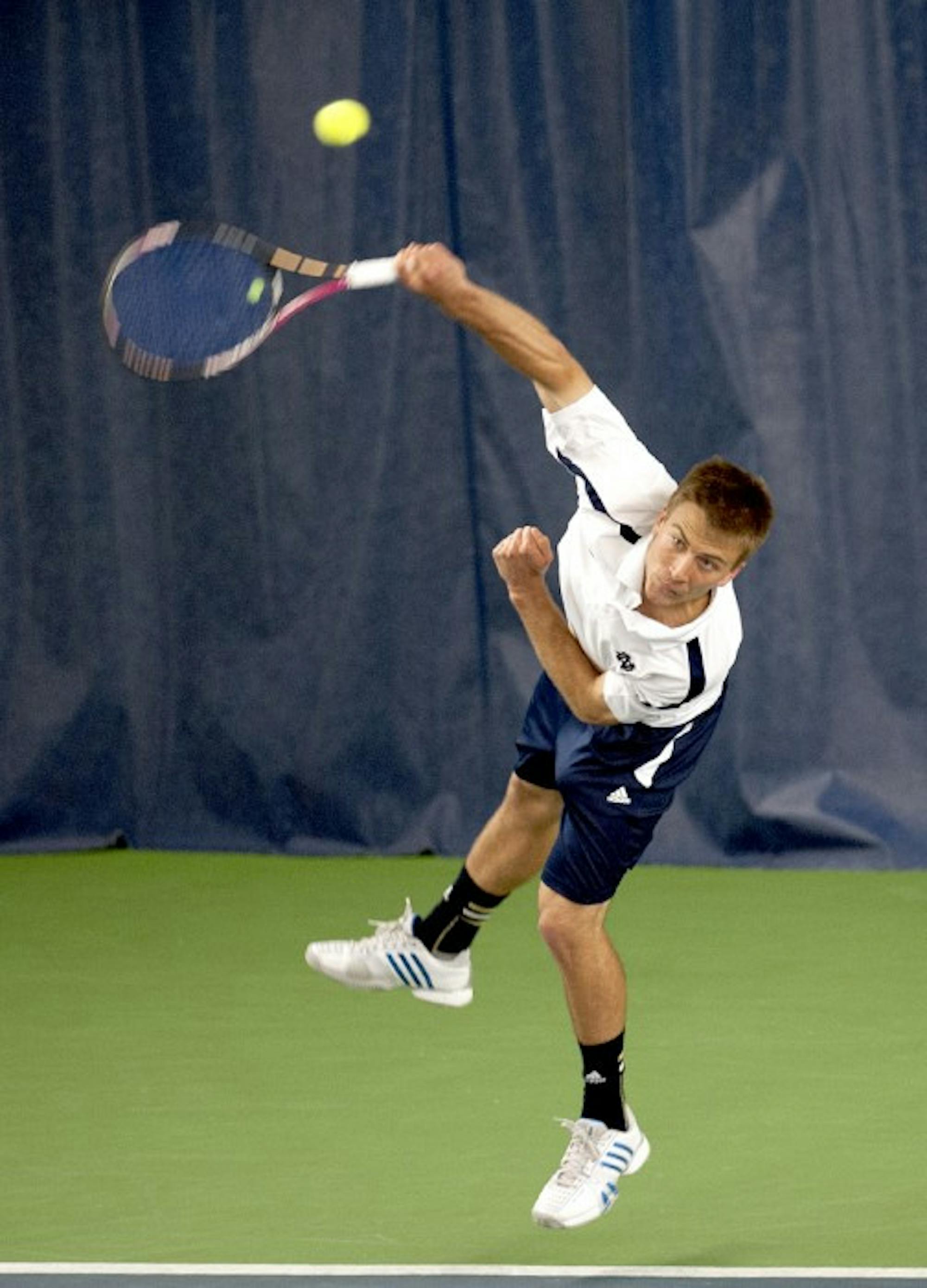 Senior Matt Dooley fires a serve against SMU on April 4. Dooley wrote about his life as a gay athlete at Notre Dame in a recent article.