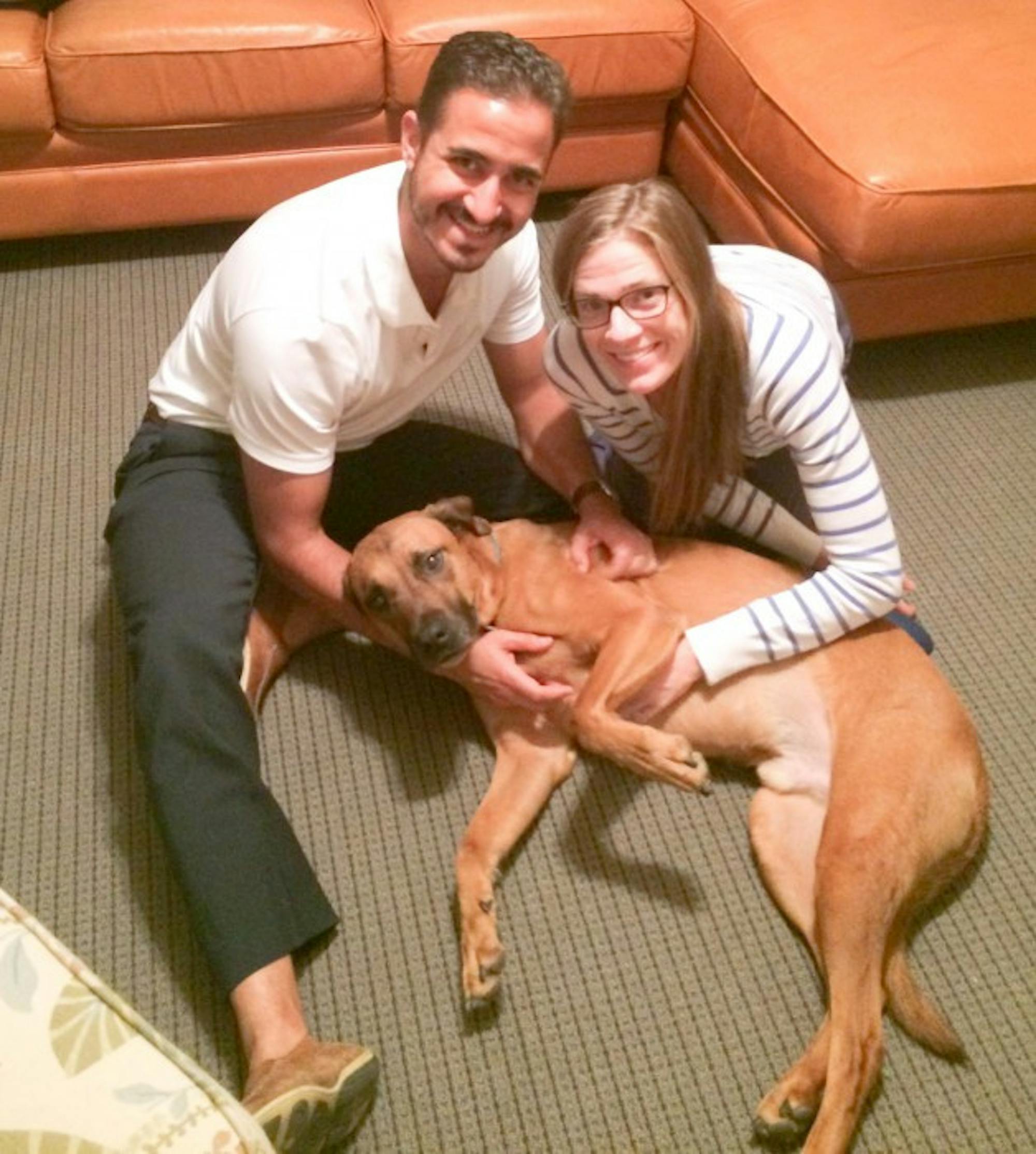 Keenan Hall rector Noel Terranova and his wife Jaclyn pose with their dog, The Goose, who lives with them in the dorm.