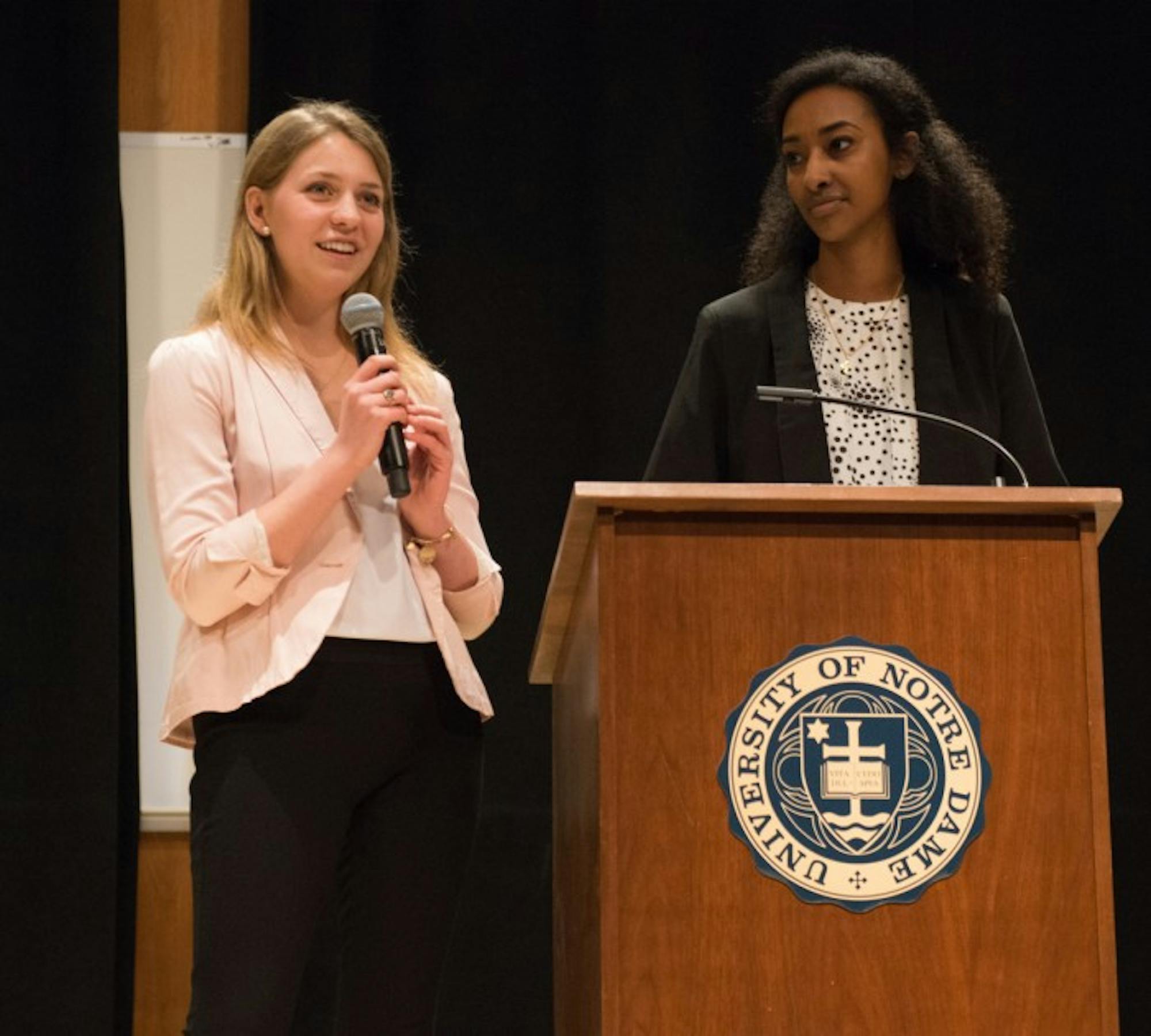 Juniors Becca Blais, left, and Sibonay Shewit speak at the student body president debate Monday at Carey Auditorium. Students voted Wednesday, electing Blais the next president and Shewit the next vice president.