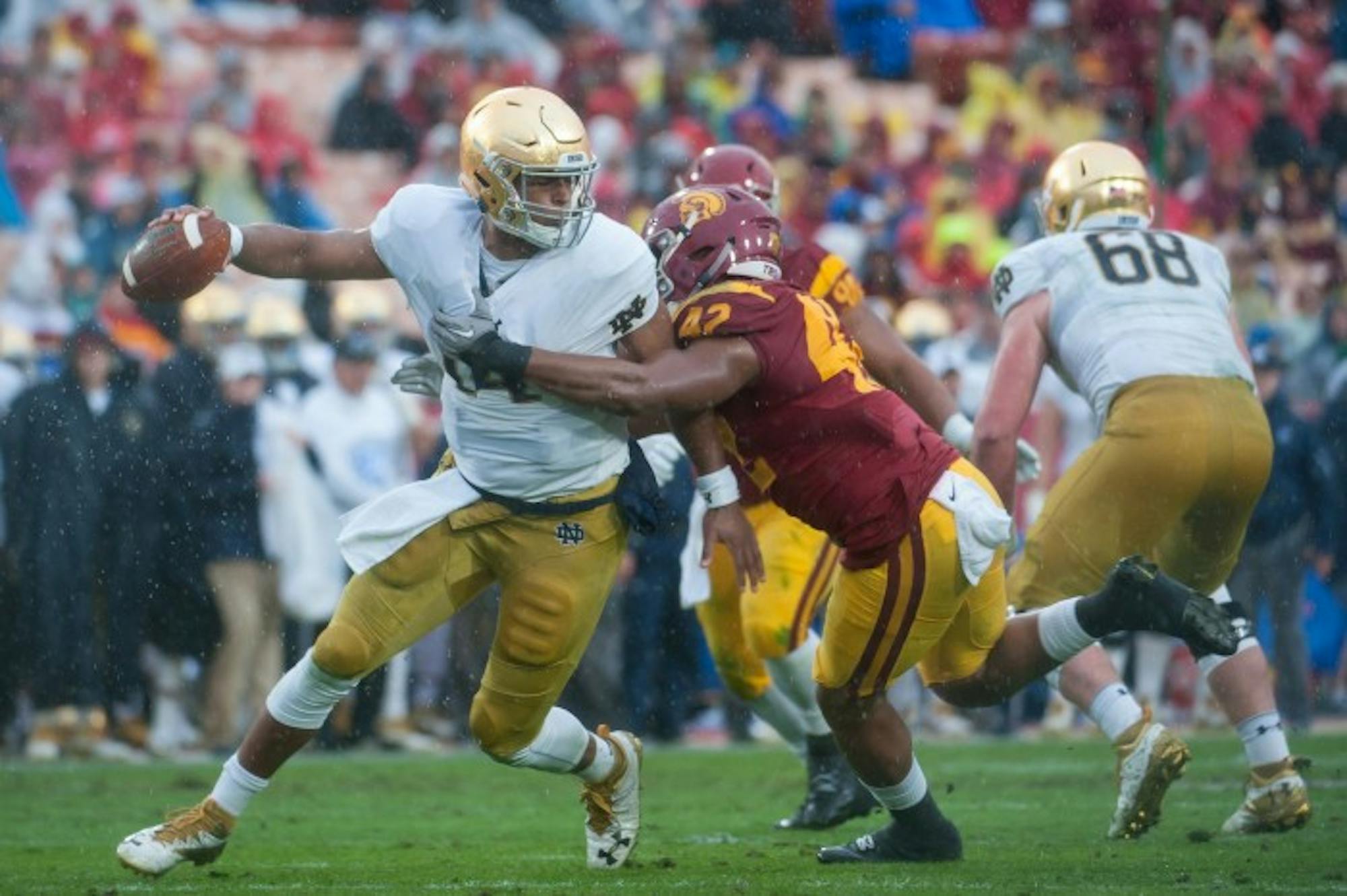 Irish junior quarterback DeShone Kizer attempts to elude a pass rusher during Notre Dame's 45-27 loss Saturday to USC.